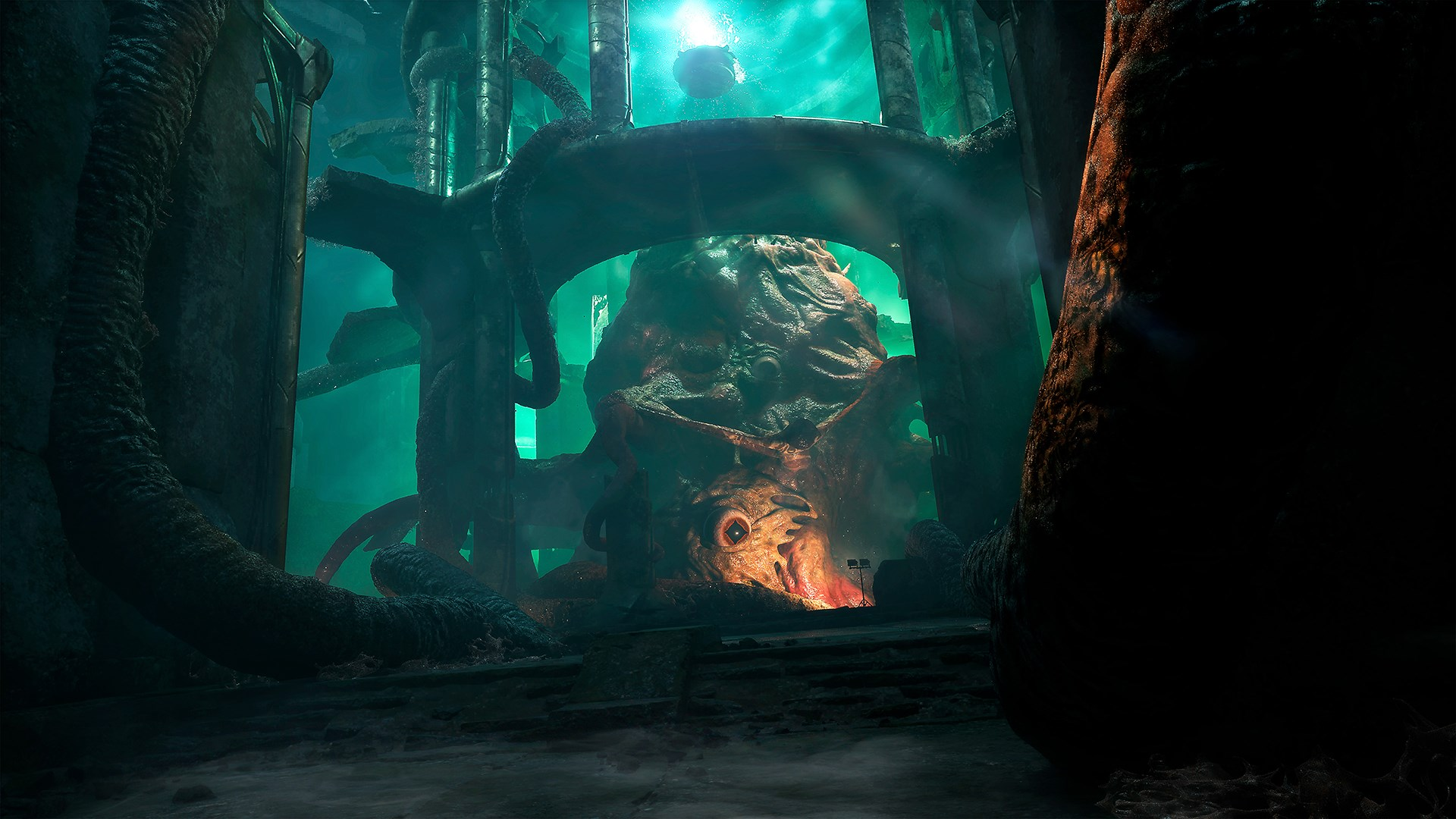Un monstre géant, rouge, avec des tentacules dans une chambre sombre éclairée en vert.