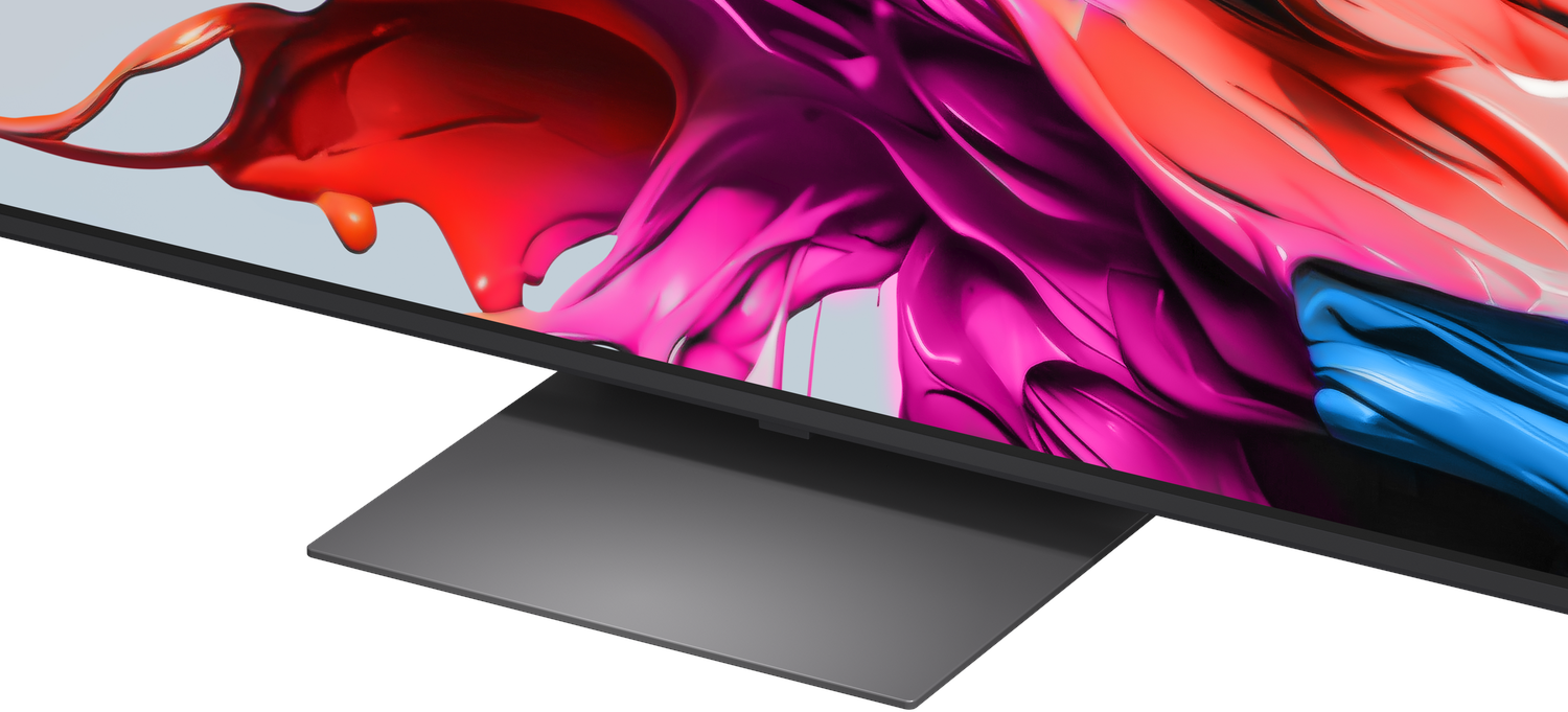 A modern monitor displaying an abstract, colorful background of red, pink, and blue.