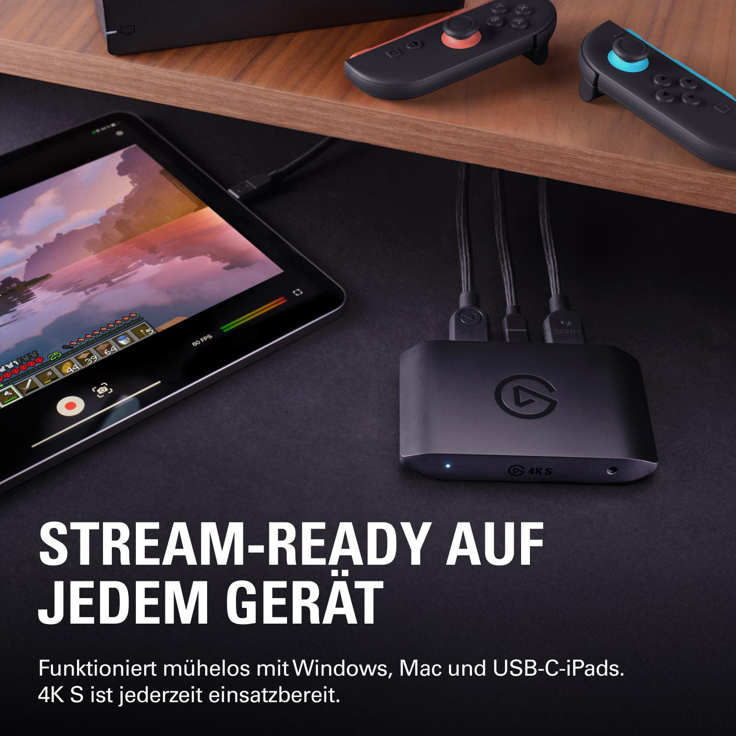 Ein schwarzer Capture Card ist mit einem Tablet verbunden, das ein Spiel zeigt.