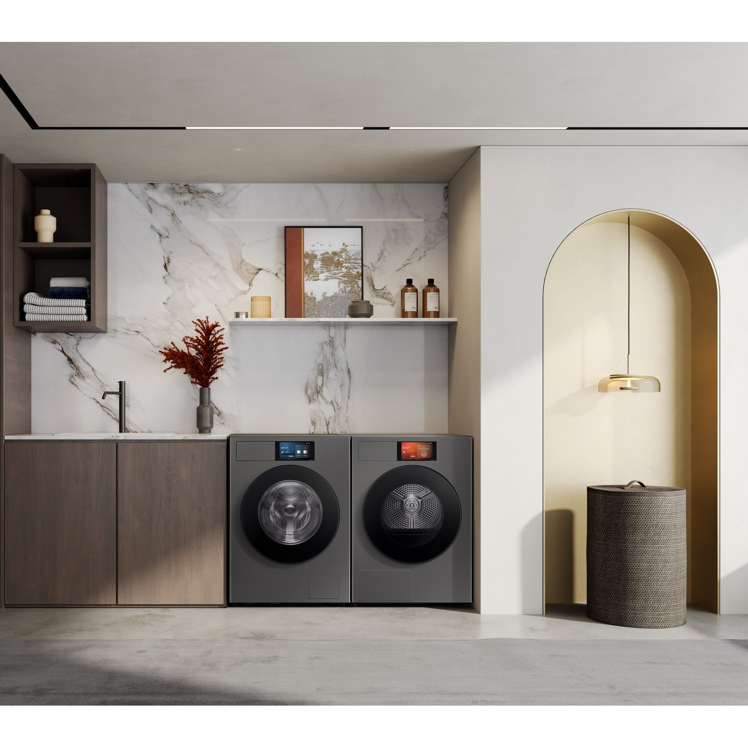 Modern laundry room with two grey appliances, marble backsplash, and laundry basket.