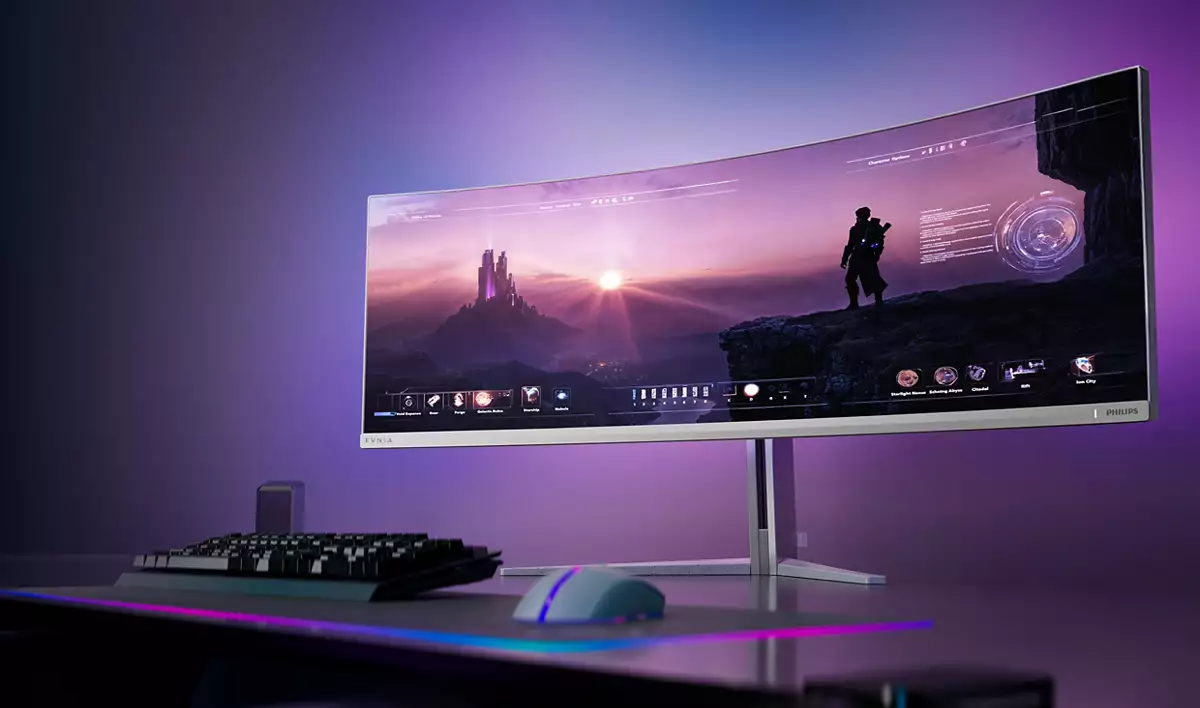 Ein gekrümmter Gaming-Monitor mit einem Fantasy-Bildschirm, Tastatur und Maus.