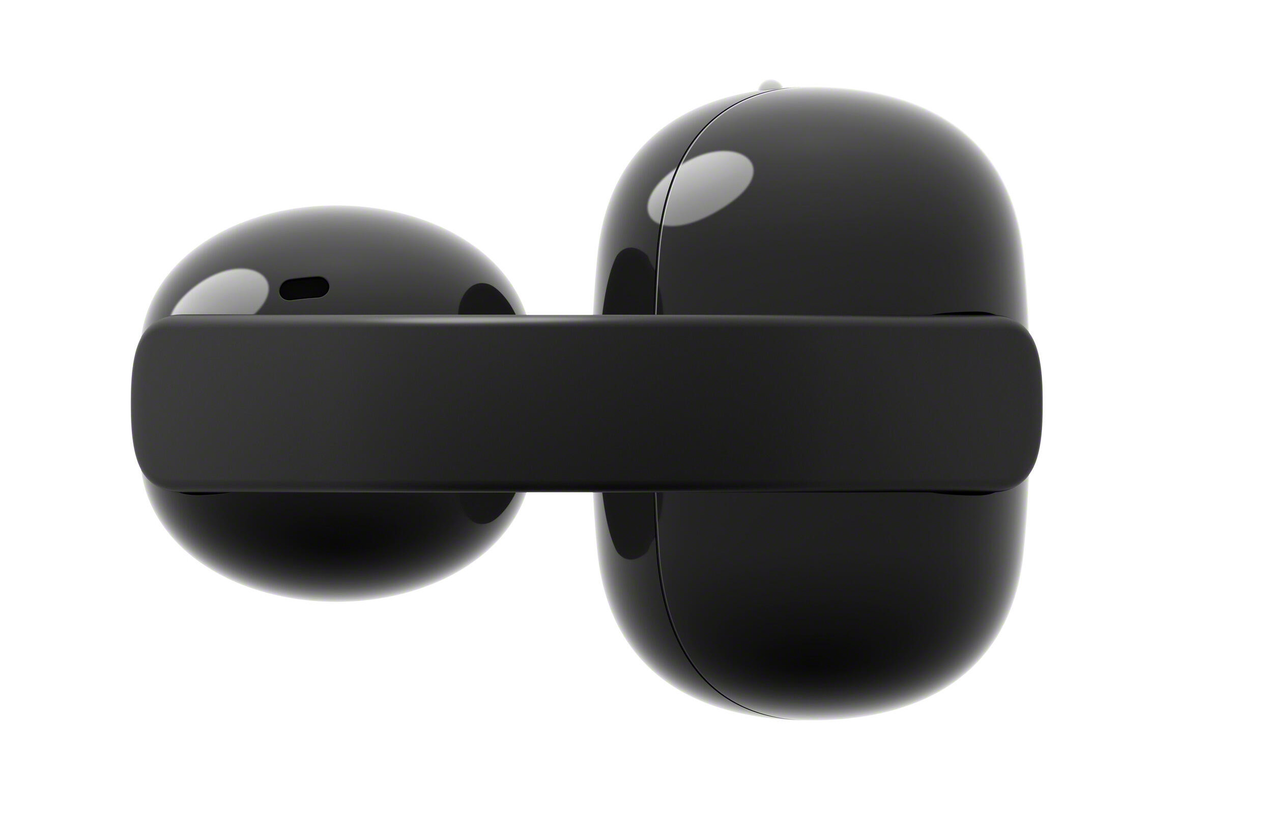 Dwa gładkie, czarne słuchawki bezprzewodowe z czarnym etui ładującym.