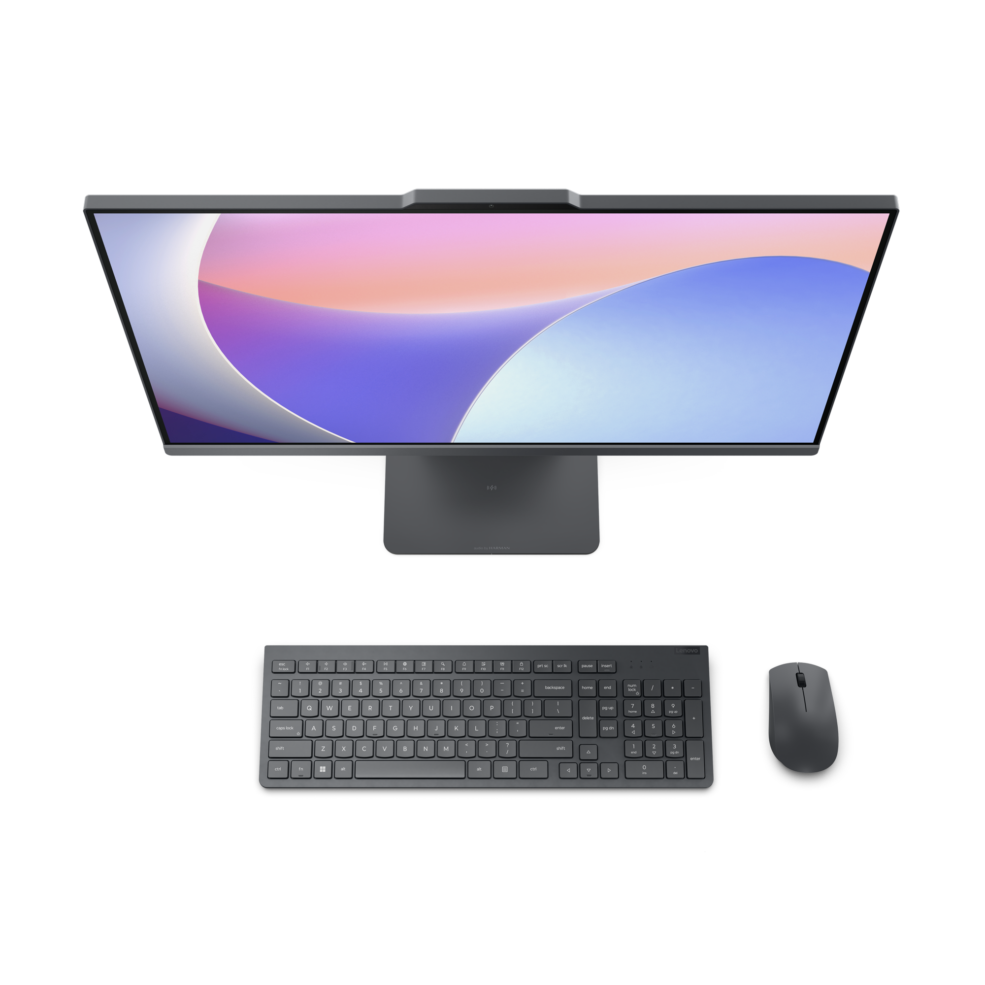 Un ordinateur tout-en-un gris avec clavier et souris sur fond noir.