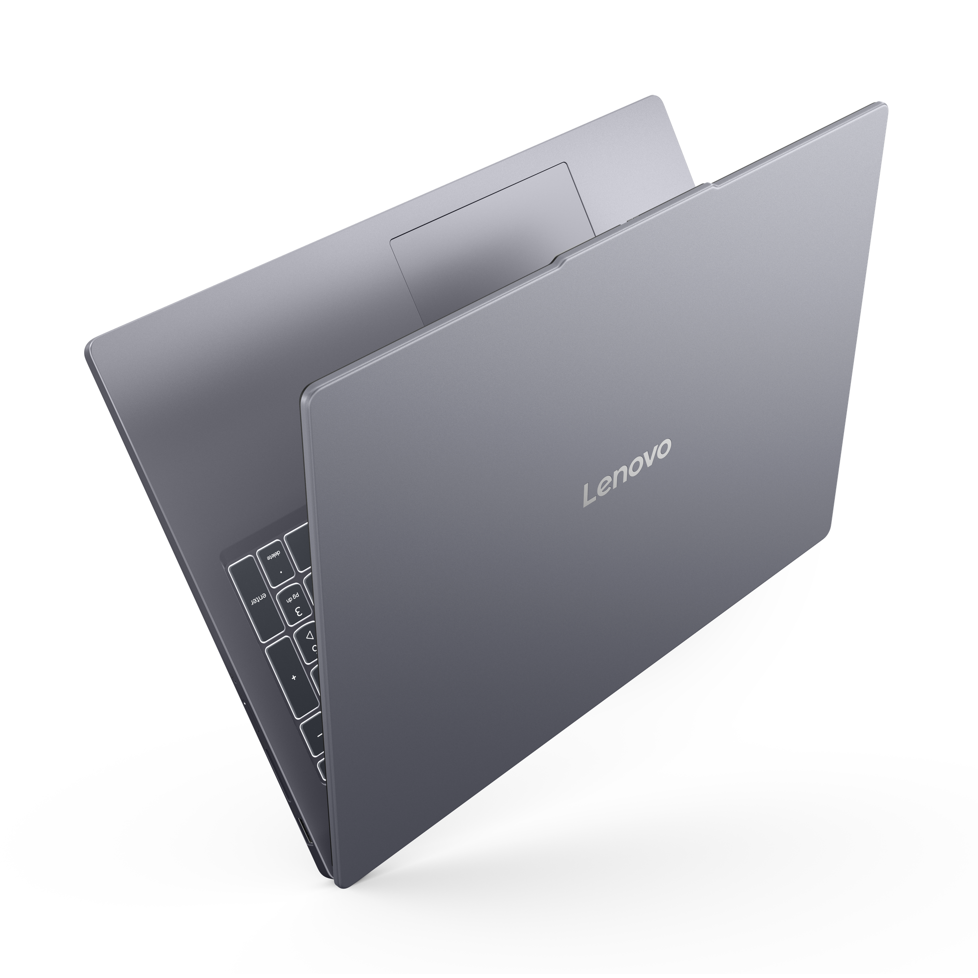 Un ordinateur portable Lenovo gris fermé avec clavier rétroéclairé sur fond noir.