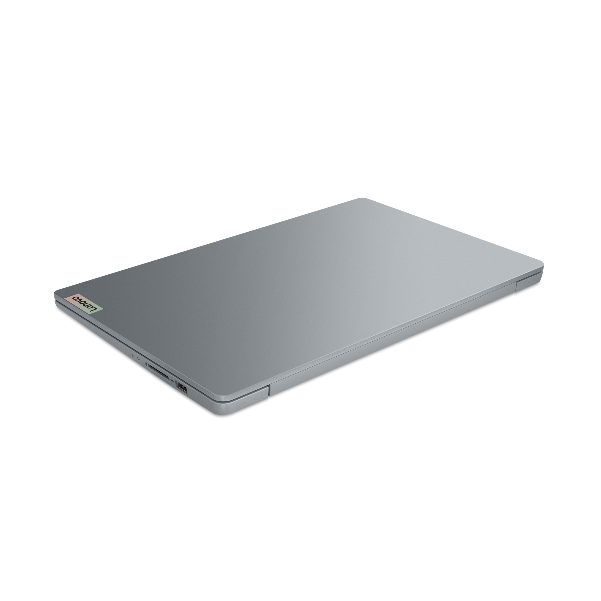 Un ordinateur portable argenté fermé avec le logo Lenovo sur le capot.