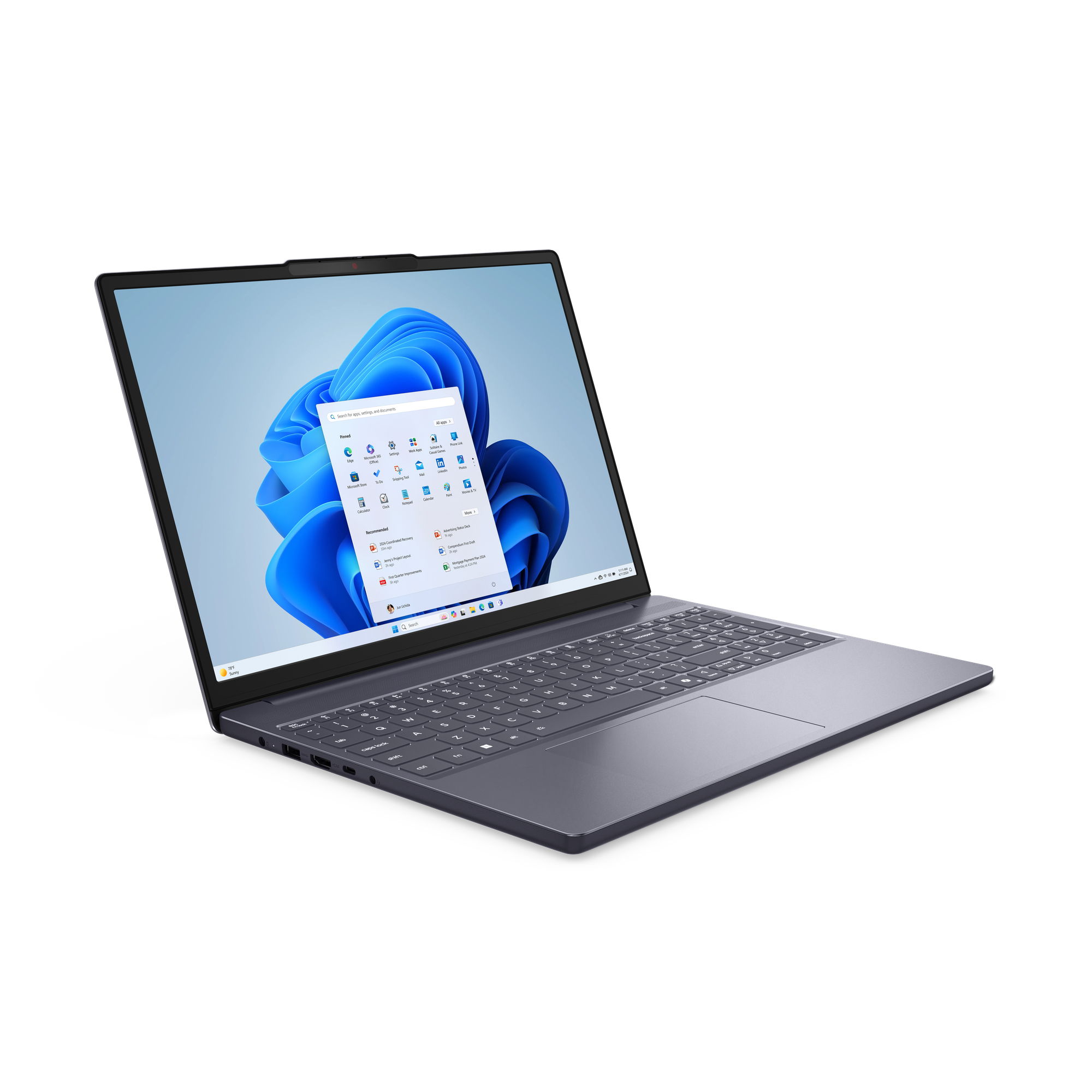 Un ordinateur portable sombre sous Windows 11 affiche un fond d'écran vague bleue.