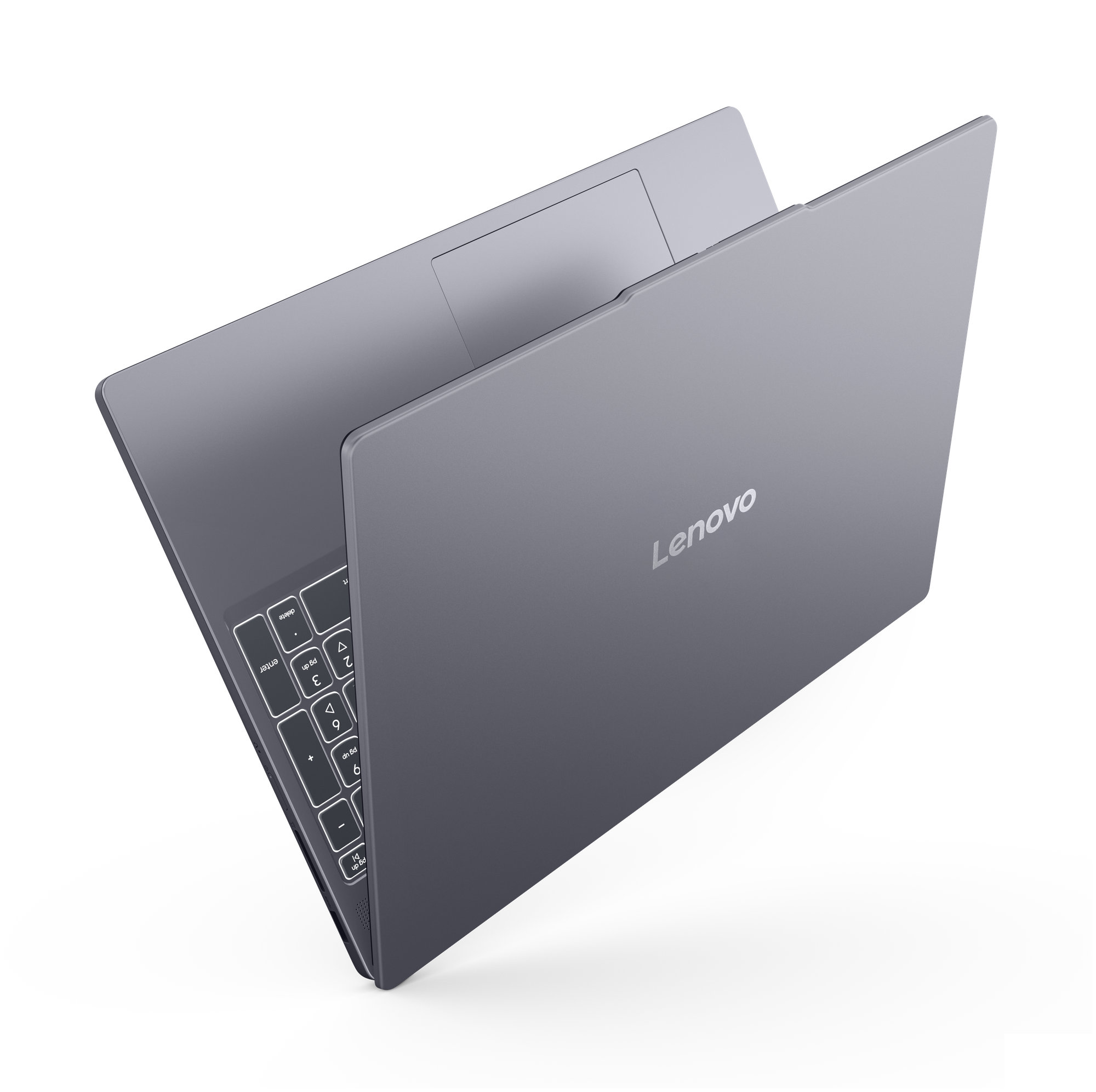 Un ordinateur portable Lenovo gris fermé avec clavier rétroéclairé sur fond noir.