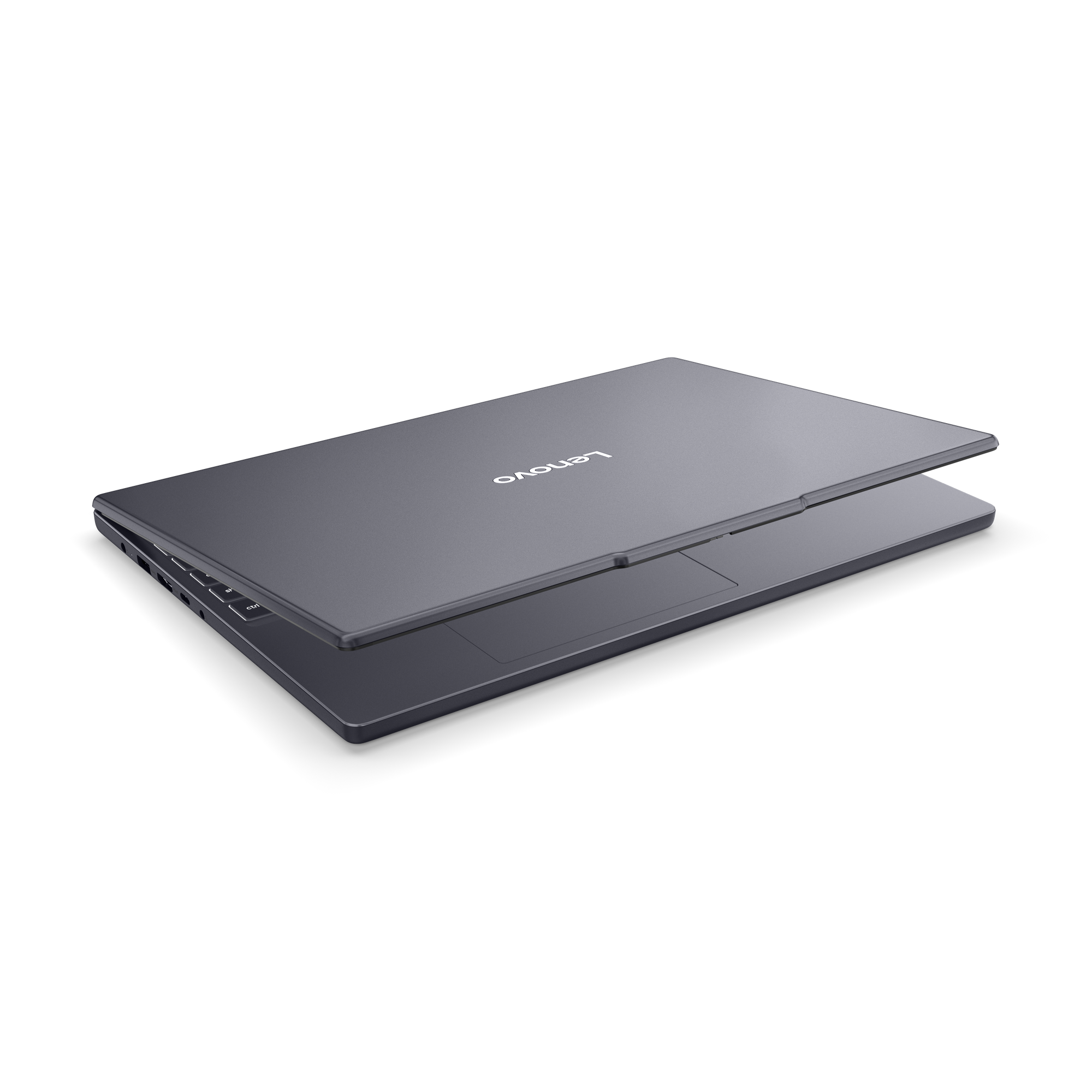 Zárt, szürke Lenovo laptop világító gombokkal, fekete háttérrel.