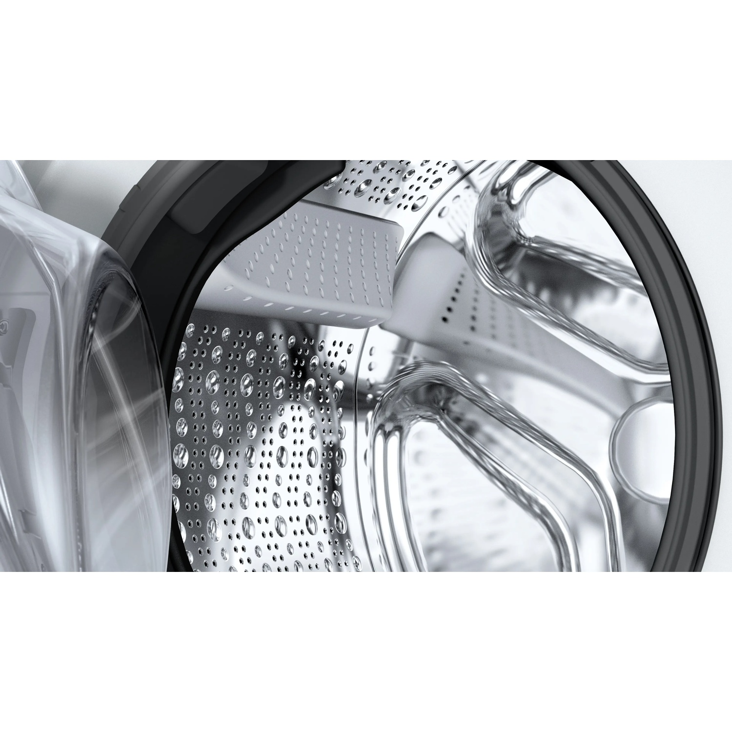 Interior view of a washing machine drum with water droplets on the metal surface.