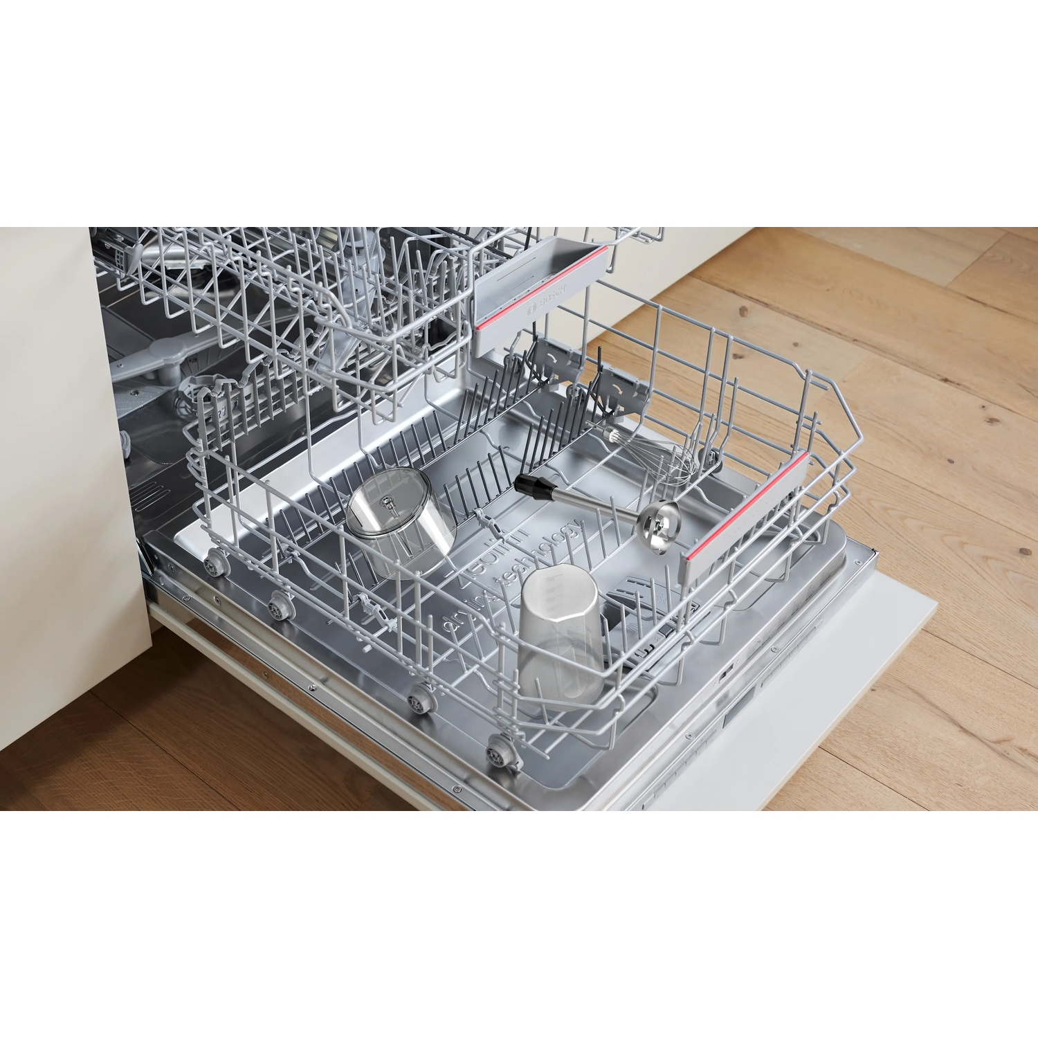 Interior view of an open dishwasher with racks and glasses.