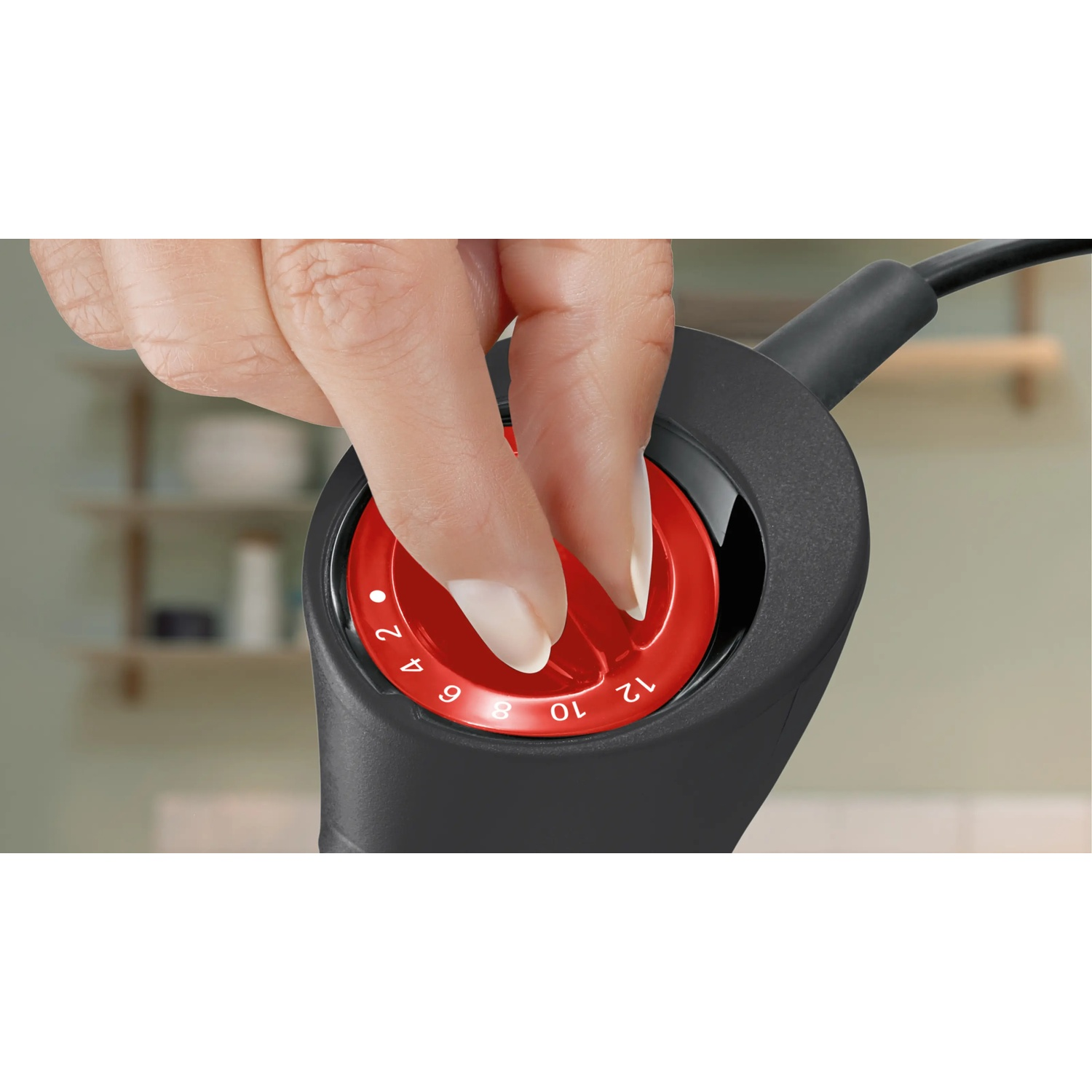 A hand turns a red dial with numbers 2, 4, 6, 8, 10, 12.