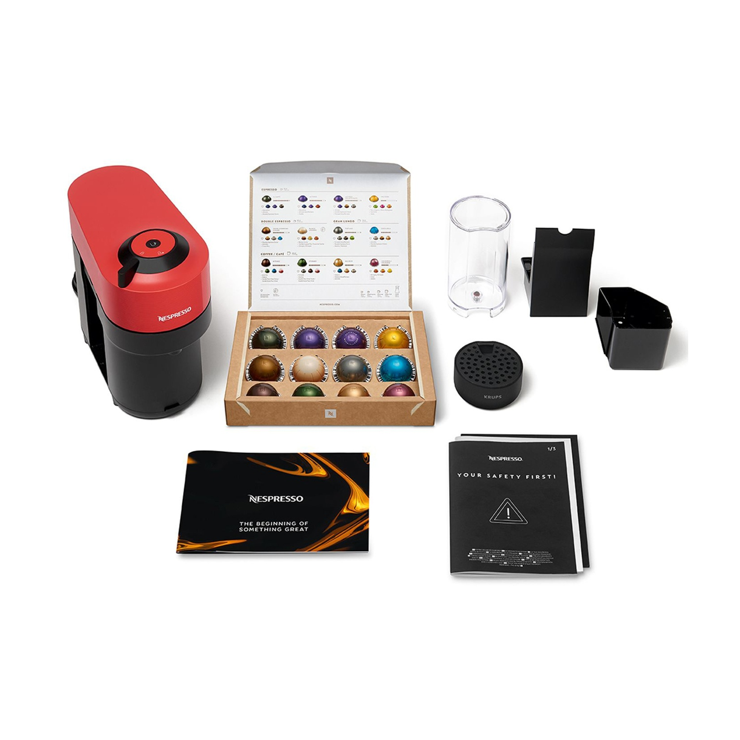 Macchina da caffè Nespresso con capsule, accessori e manuali.