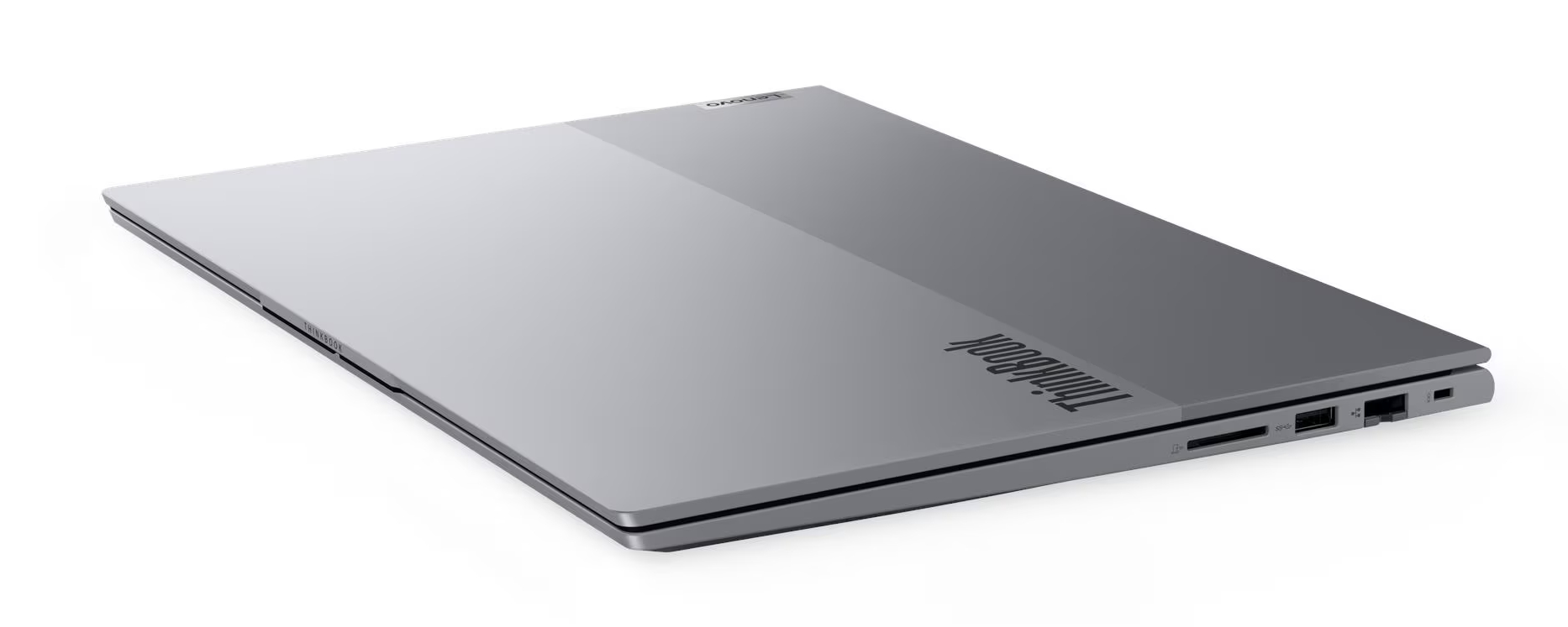 Zamknięty srebrny laptop z logo ThinkBook, białe tło.