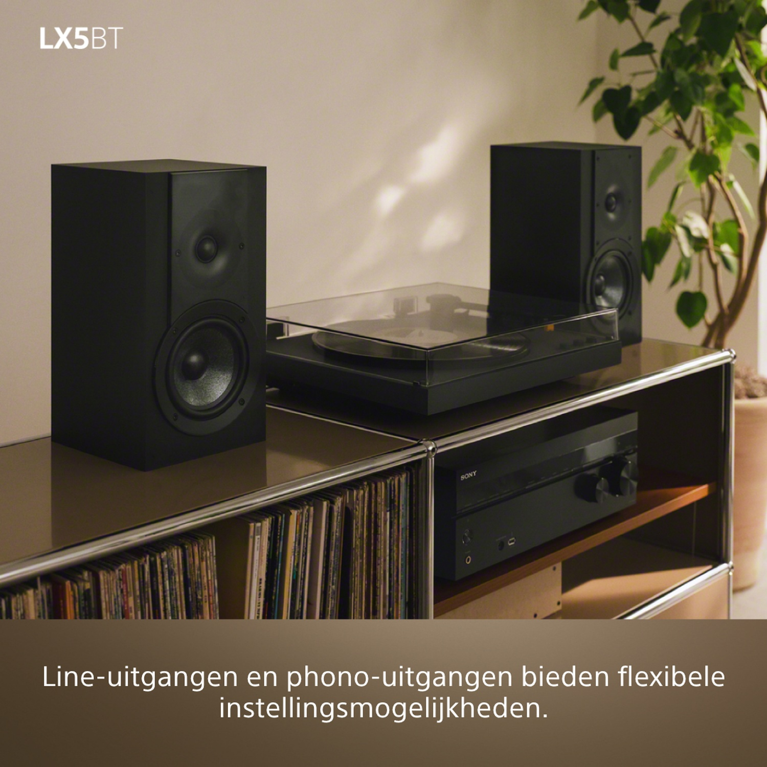 Black speakers, turntable, and amplifier on a shelf with records.