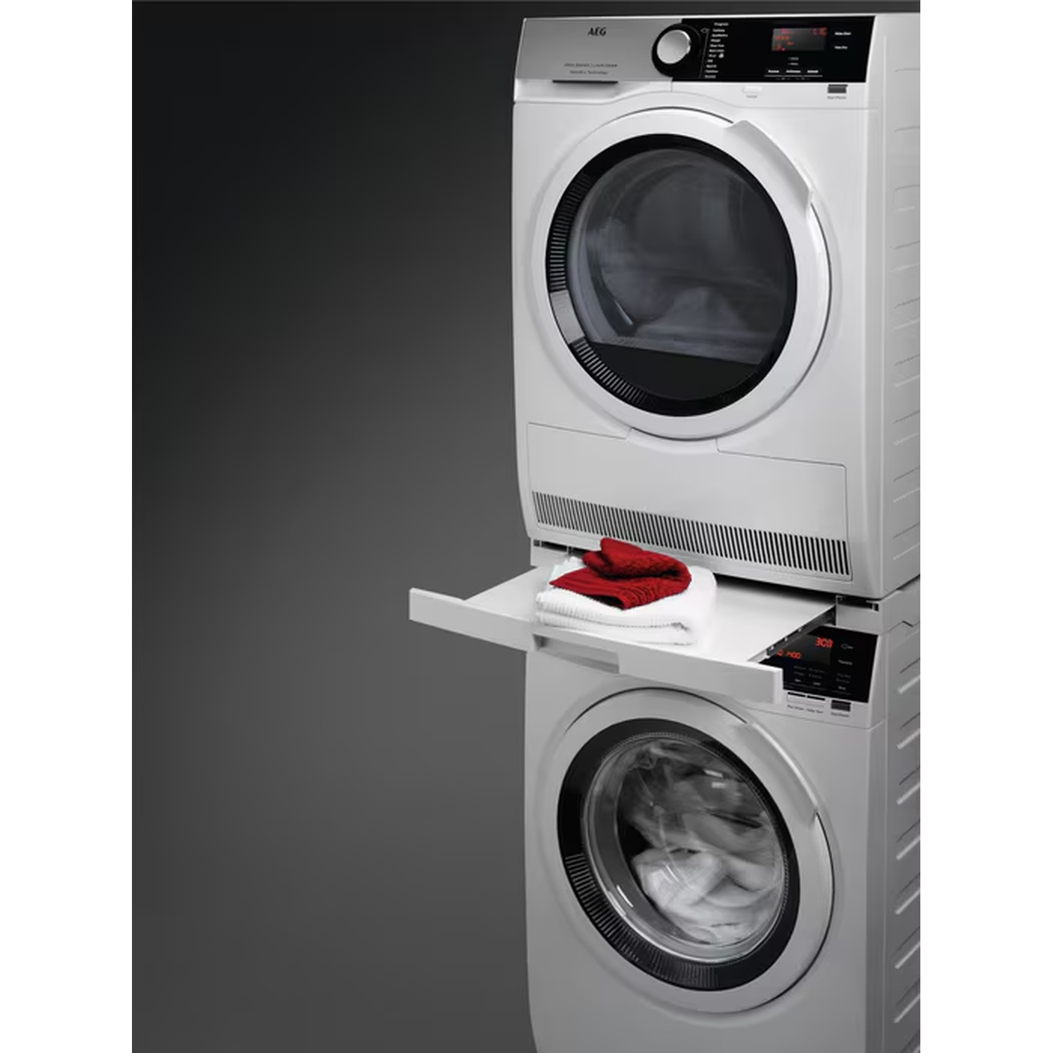 Lave-linge et sèche-linge blancs empilés avec un tiroir à linge.