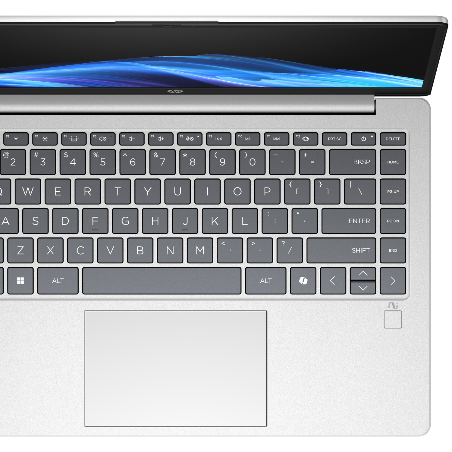 Silver laptop keyboard and screen with blue abstract wallpaper. Close-up view.