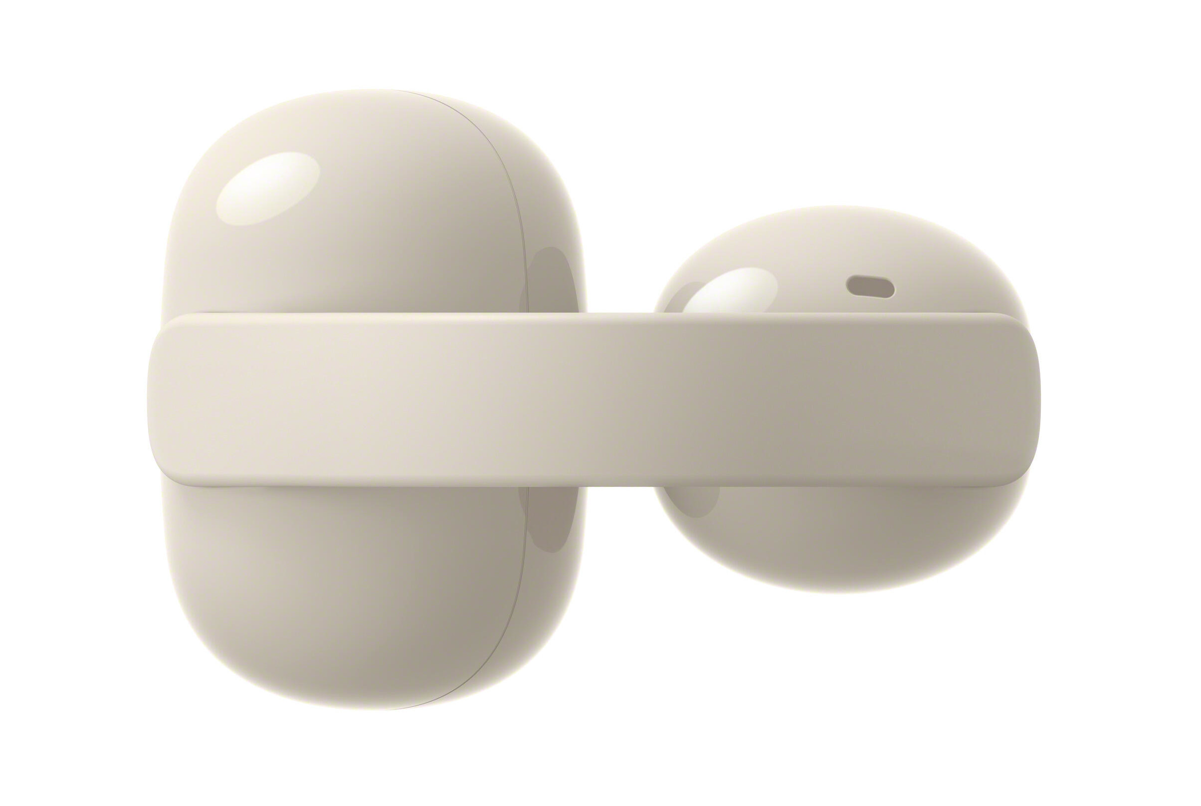 Dwa beżowe słuchawki z etui ładującym, białe tło.