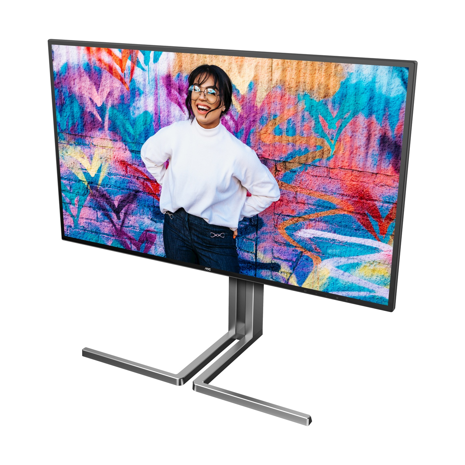 Una donna ride davanti a un muro di graffiti colorati su un monitor.