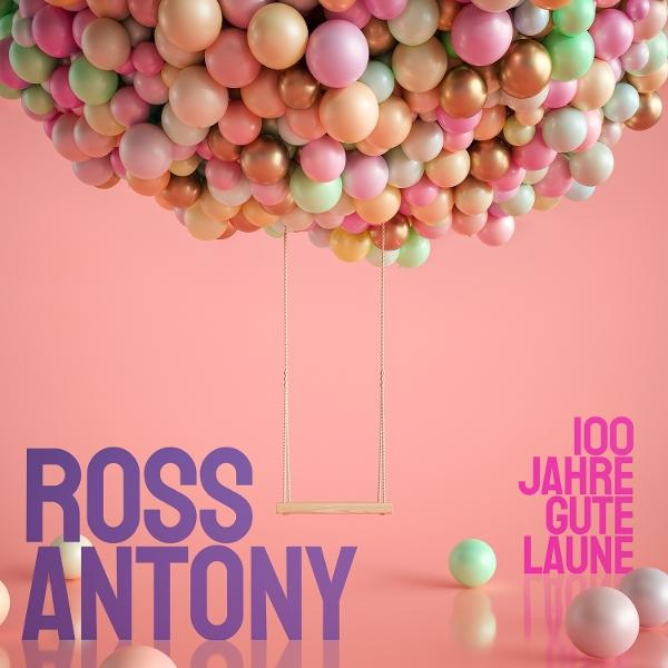 Ein Schaukelbrett hängt von vielen bunten Ballons. Text: ROSS ANTONY.