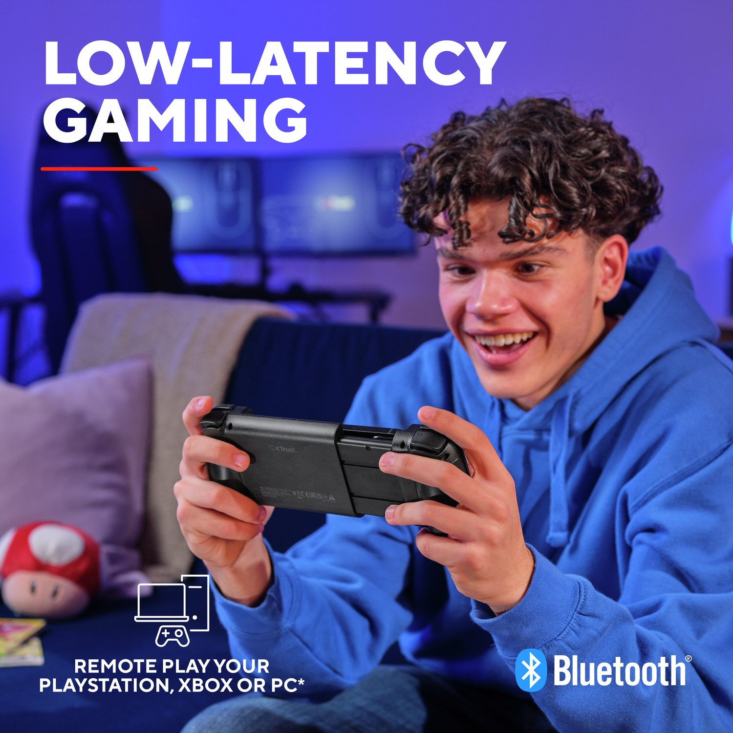 A young person smiles while playing with a controller. Low-latency gaming.
