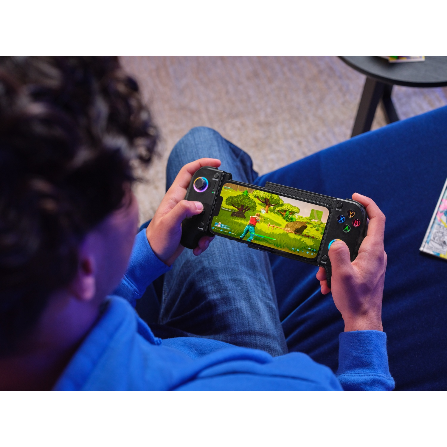 Person playing a video game on a phone with a controller.