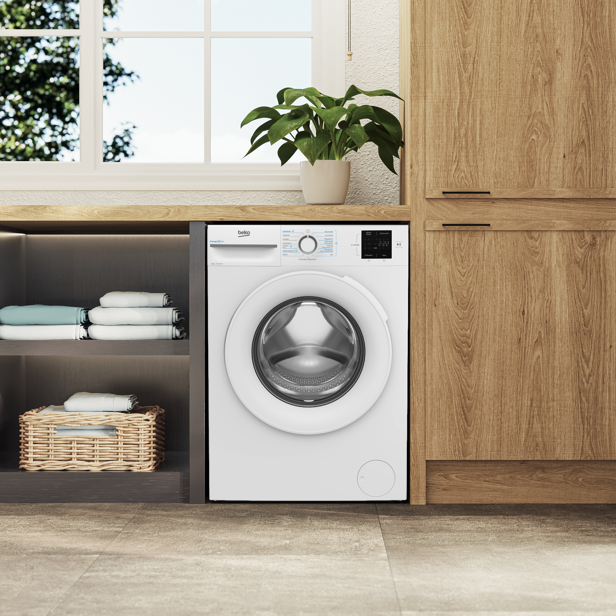 Ein weißer Beko-Waschtrockner steht neben einem Holzschrank. Darunter sind sauber gefaltete Wäsche und ein Korb.