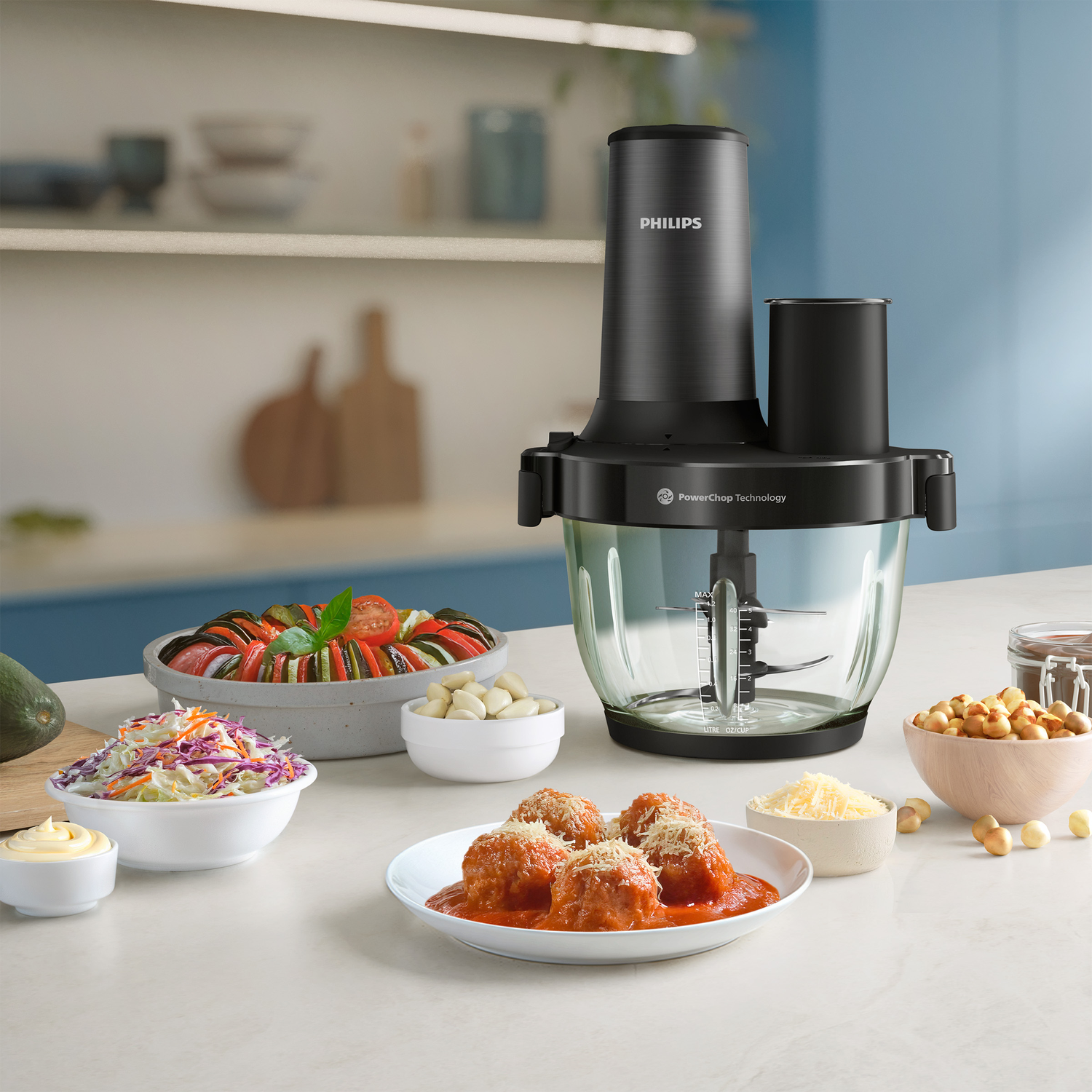 Philips food processor with foods like meatballs, ratatouille, salad, and nuts.