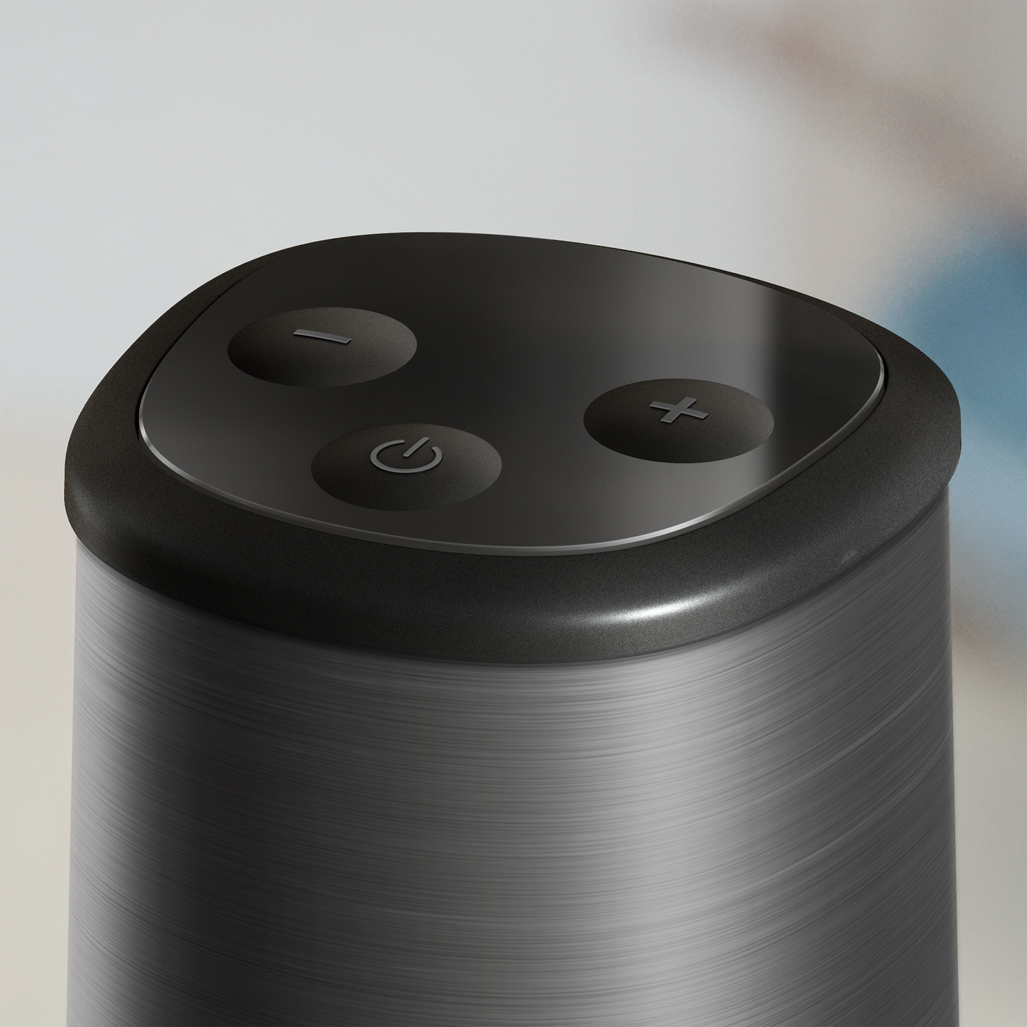 Close-up of a black top with three buttons: power, volume down, and volume up.