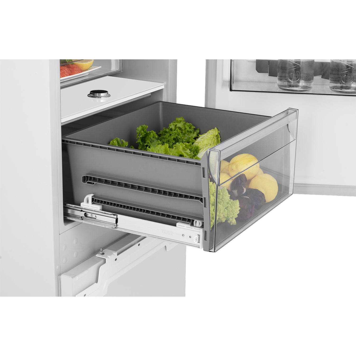 A refrigerator drawer with lettuce, lemons, Romanesco, and beets.