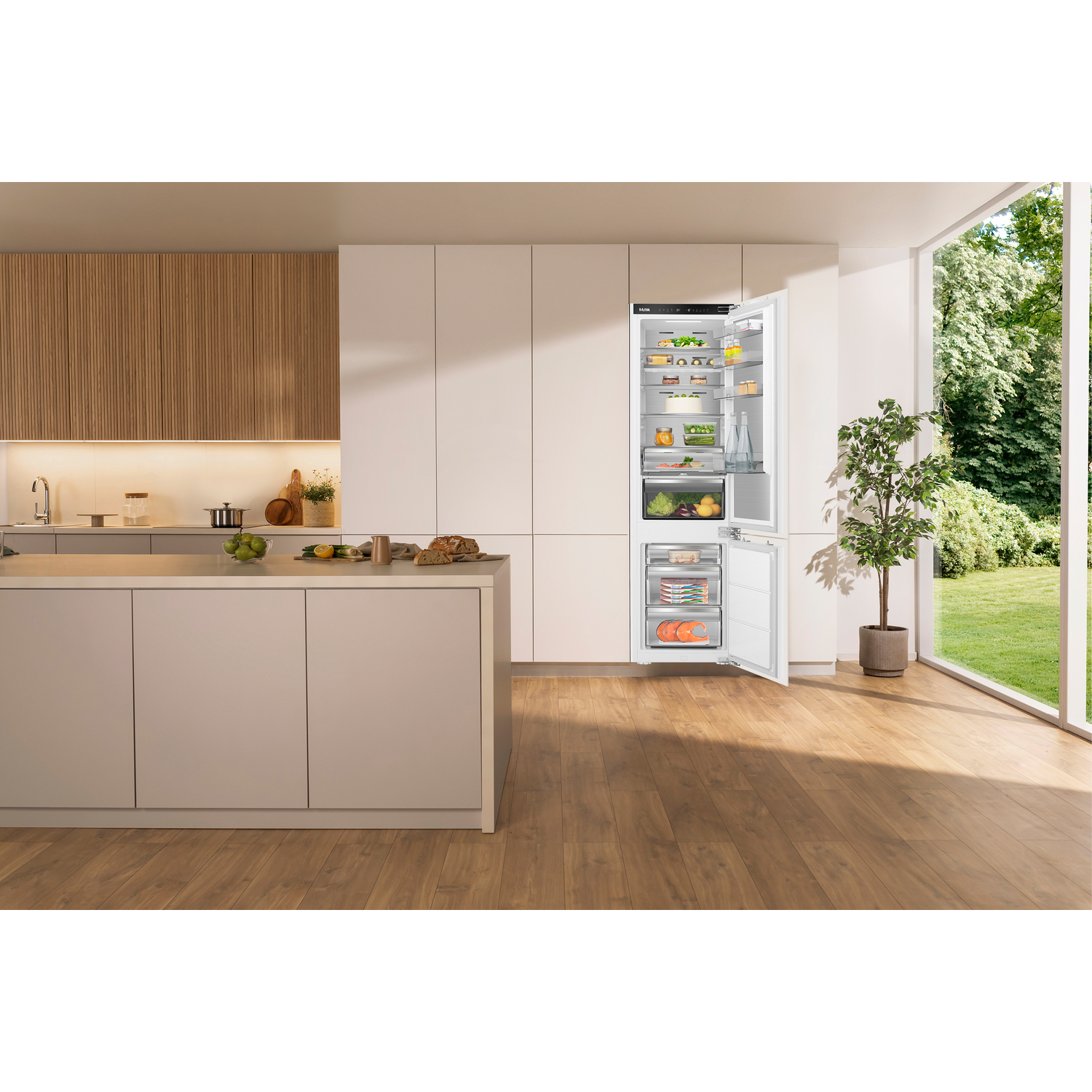 A built-in refrigerator with an open compartment in a modern kitchen with wood accents.
