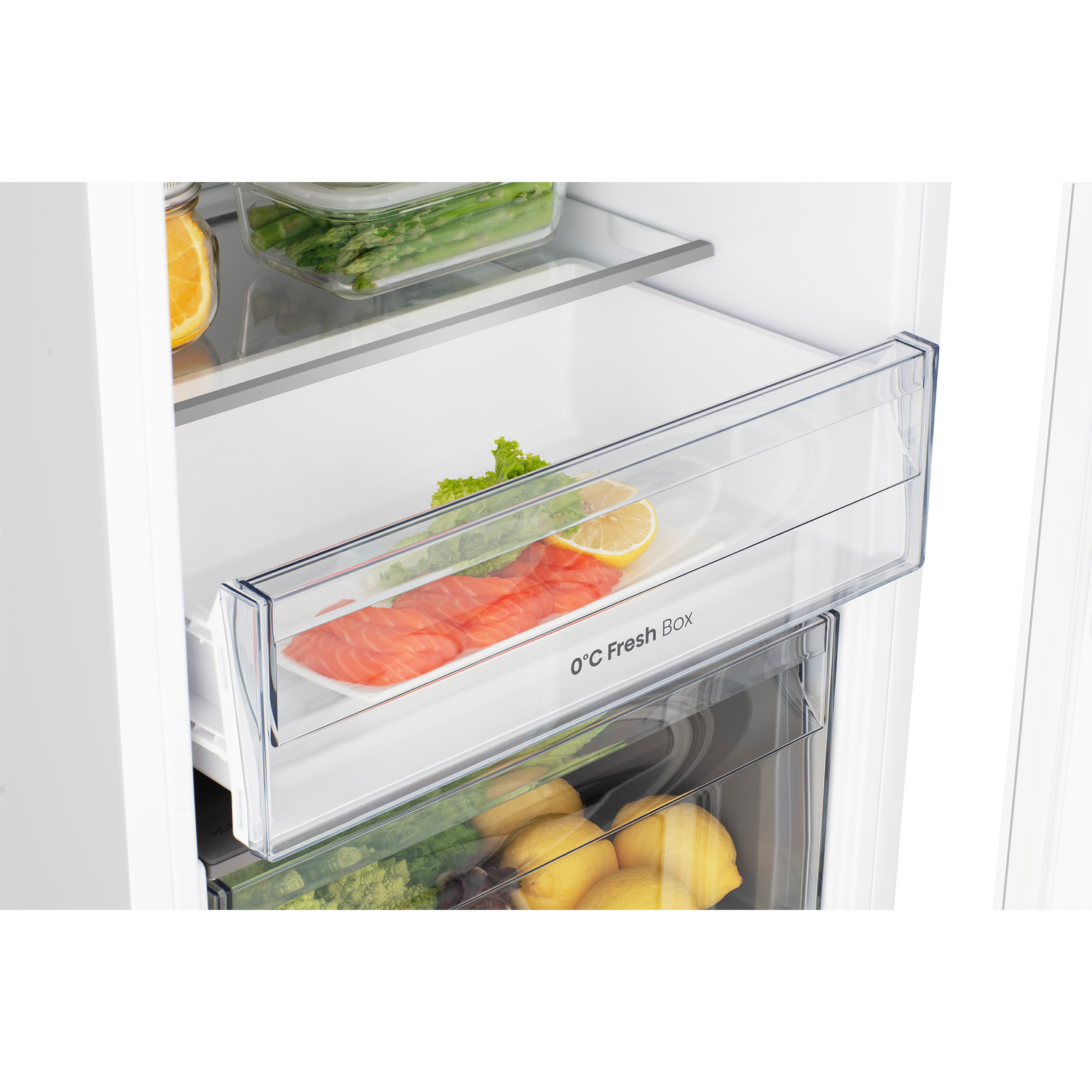 Fresh food in a refrigerator: salmon, lettuce, lemons, asparagus.