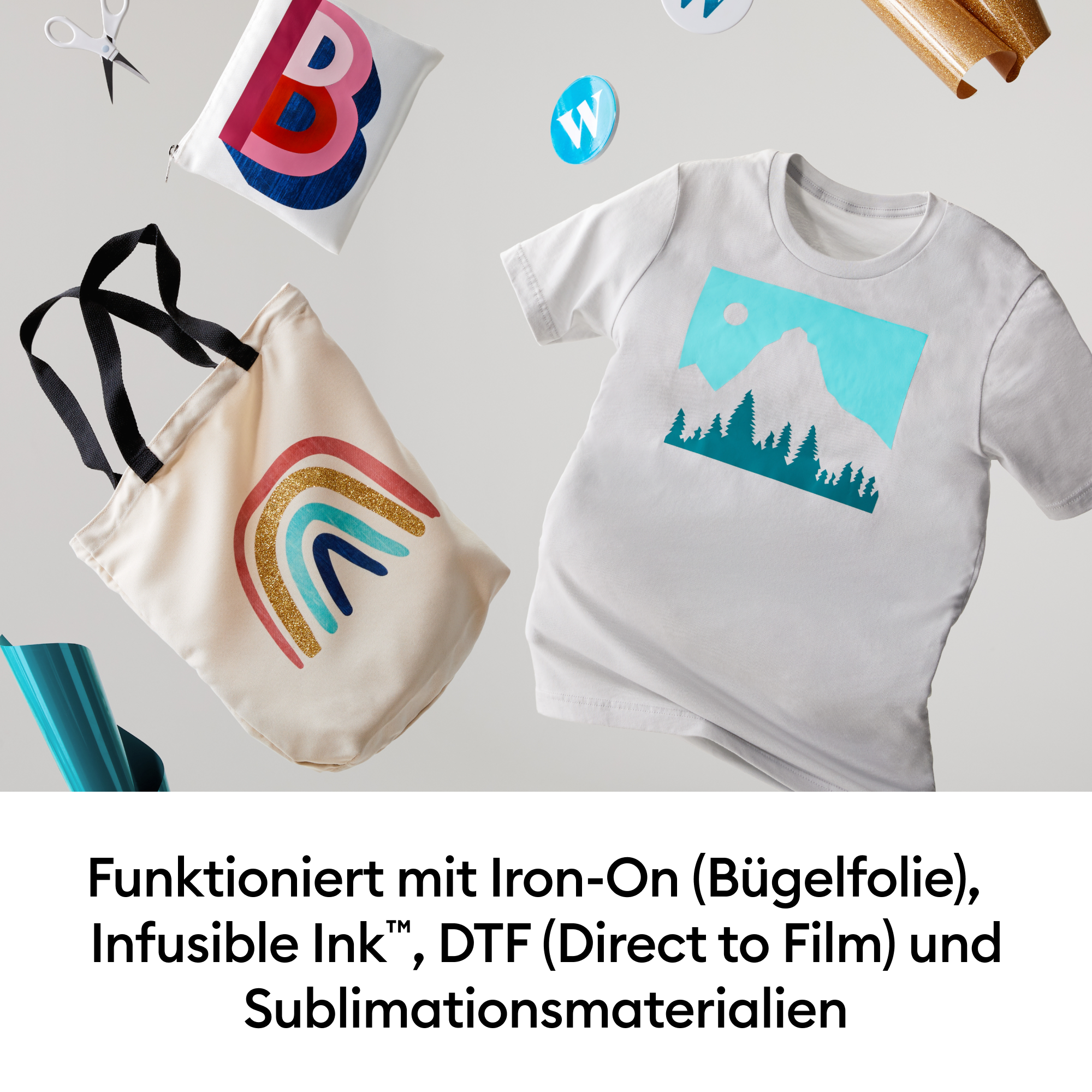 Tote Bag mit Regenbogen, T-Shirt mit Bergmotiv, Schere, Folienrolle.