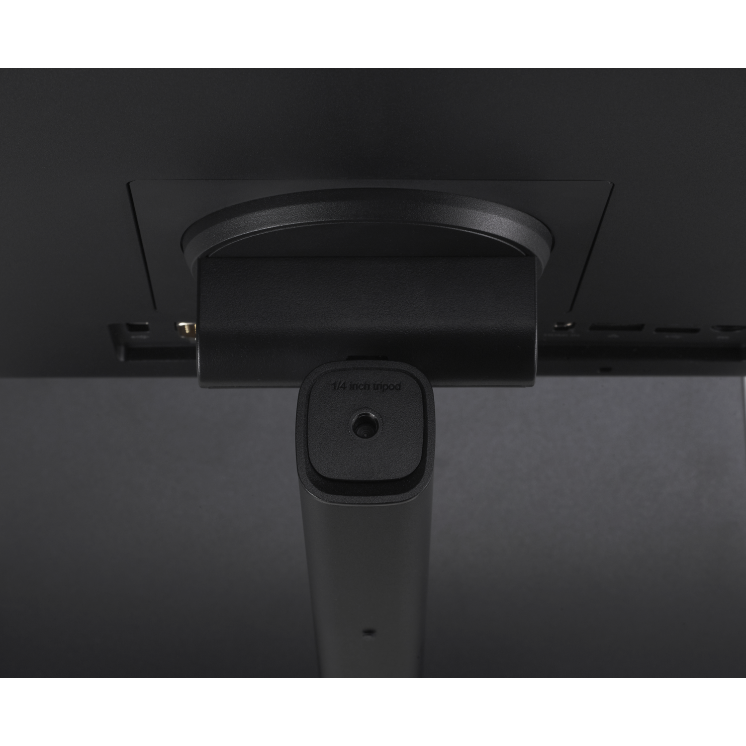 Close-up of a black monitor stand with a 1/4 inch tripod mount.
