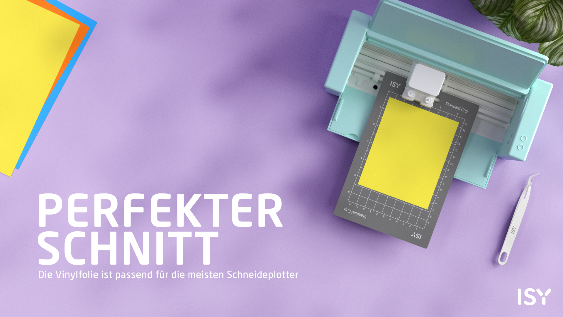 Ein mintgrüner Schneideplotter mit gelbem Papier auf einer Matte.
