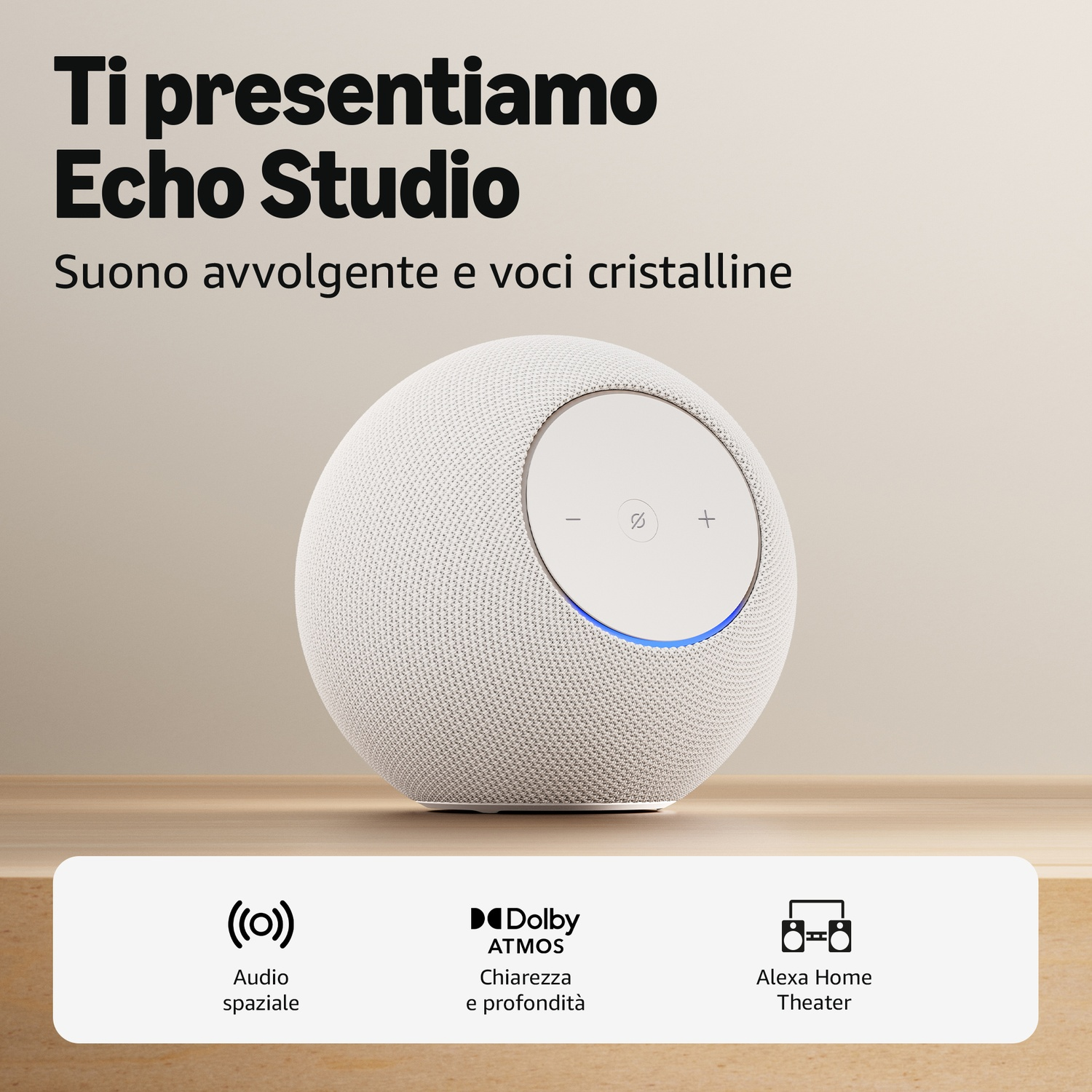 Altoparlante Echo Studio con luce blu su tavolo di legno. Loghi Dolby Atmos.