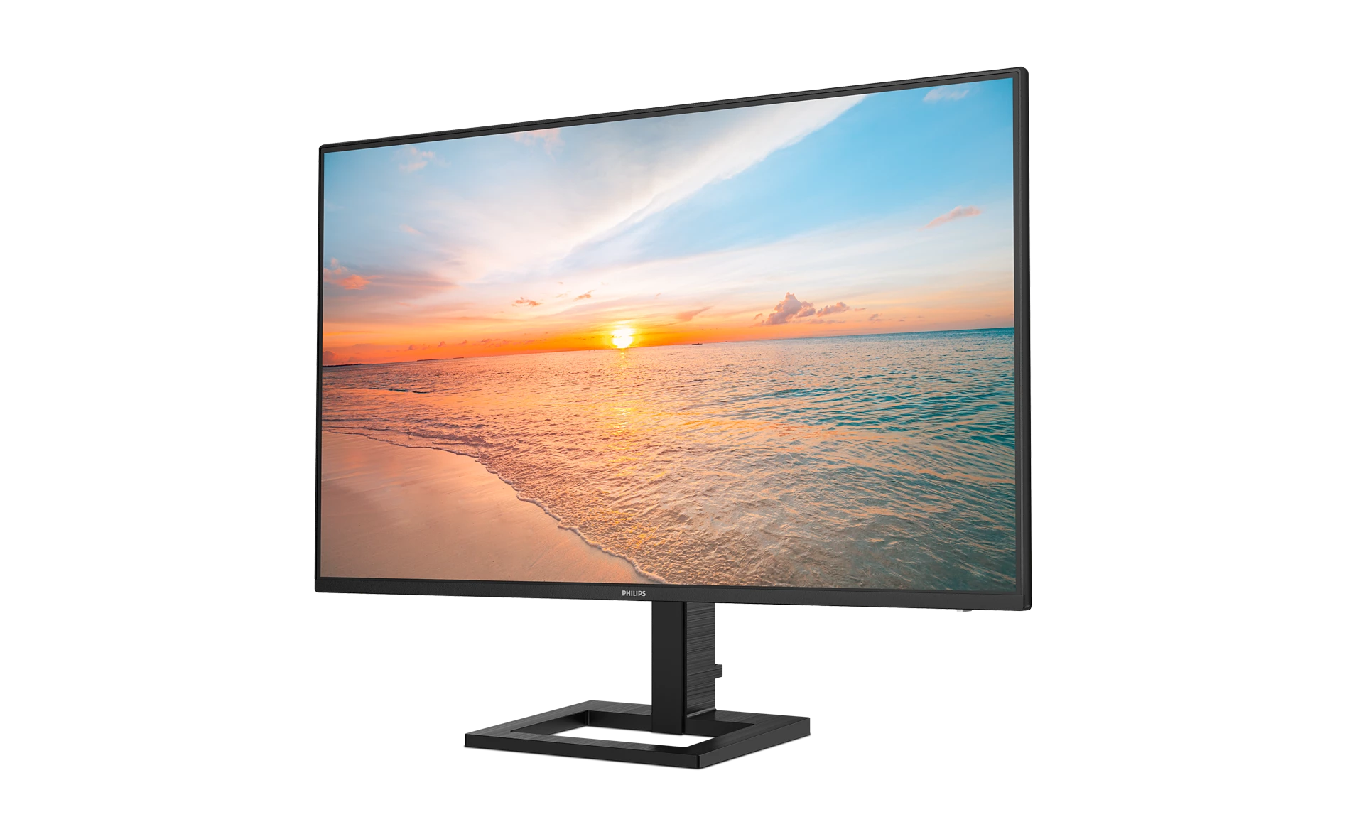 Un monitor muestra un atardecer en la playa con olas y nubes.