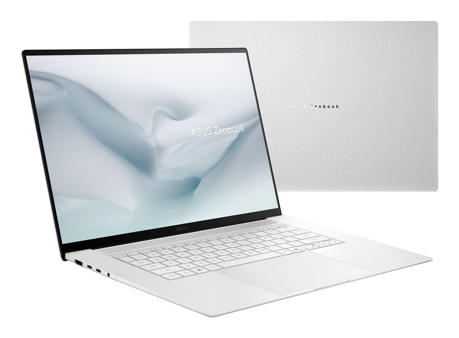 Un portátil Asus Zenbook plateado se muestra sobre fondo blanco. Un portátil está abierto, el otro cerrado.