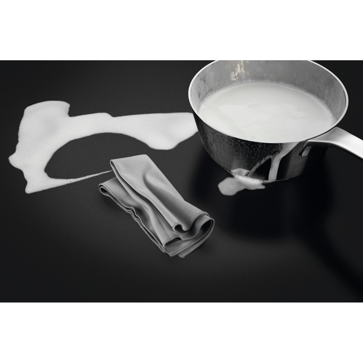 A pot with white liquid and foam on a black stovetop with a gray cloth.