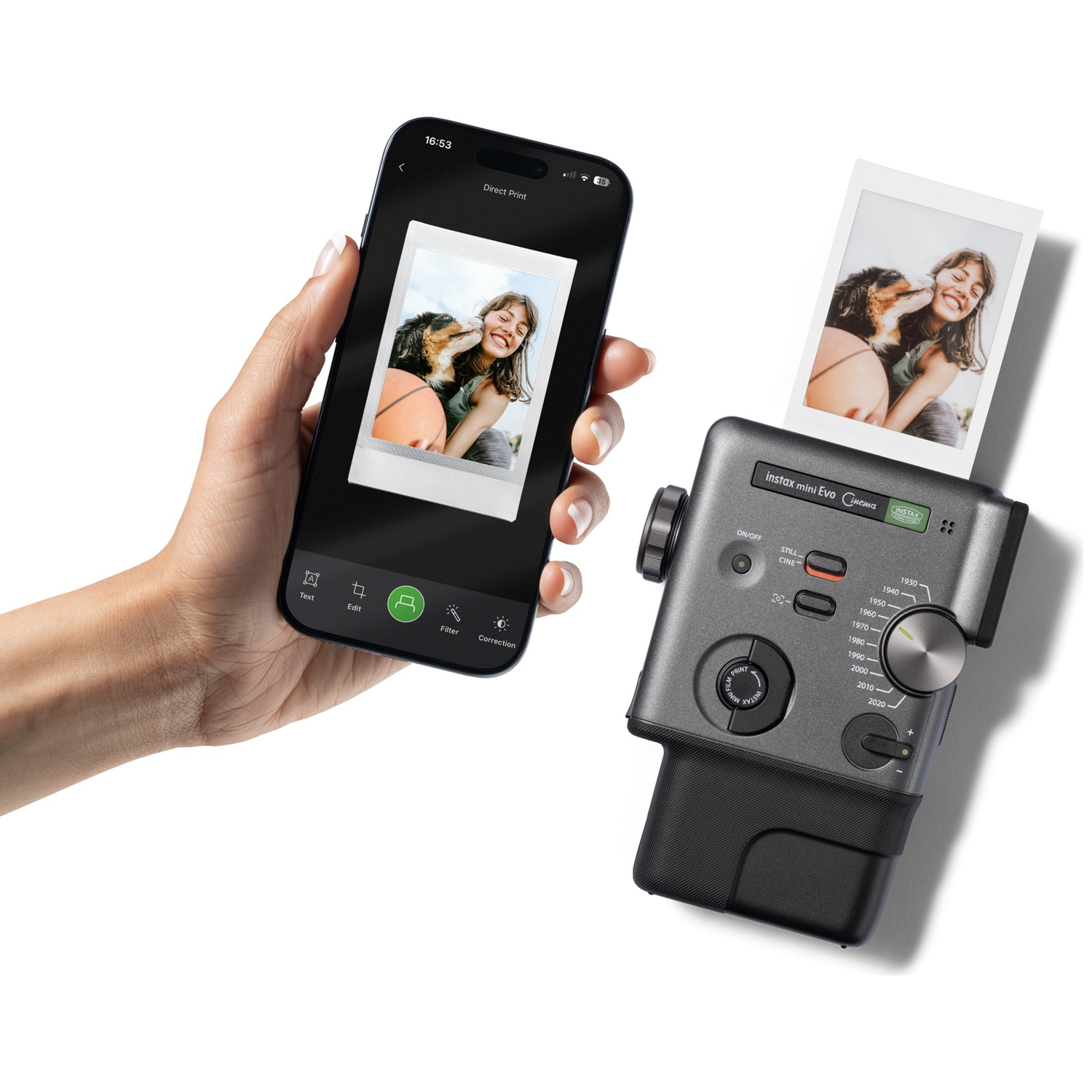 A hand holds a smartphone next to a printer outputting a photo.