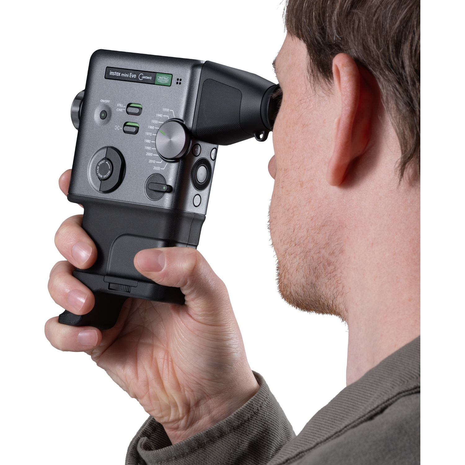 Person looks through a gray Instax Mini Evo camera viewfinder.