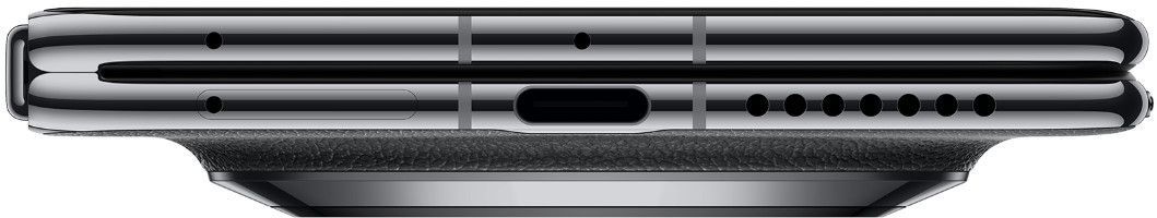 Zbliżenie zamkniętego składanego telefonu z portem ładowania i otworami głośników.