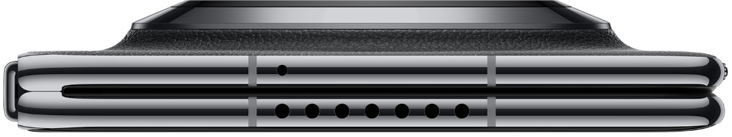 Zbliżenie srebrnego iPhone'a z czarną krawędzią i otworami głośników.