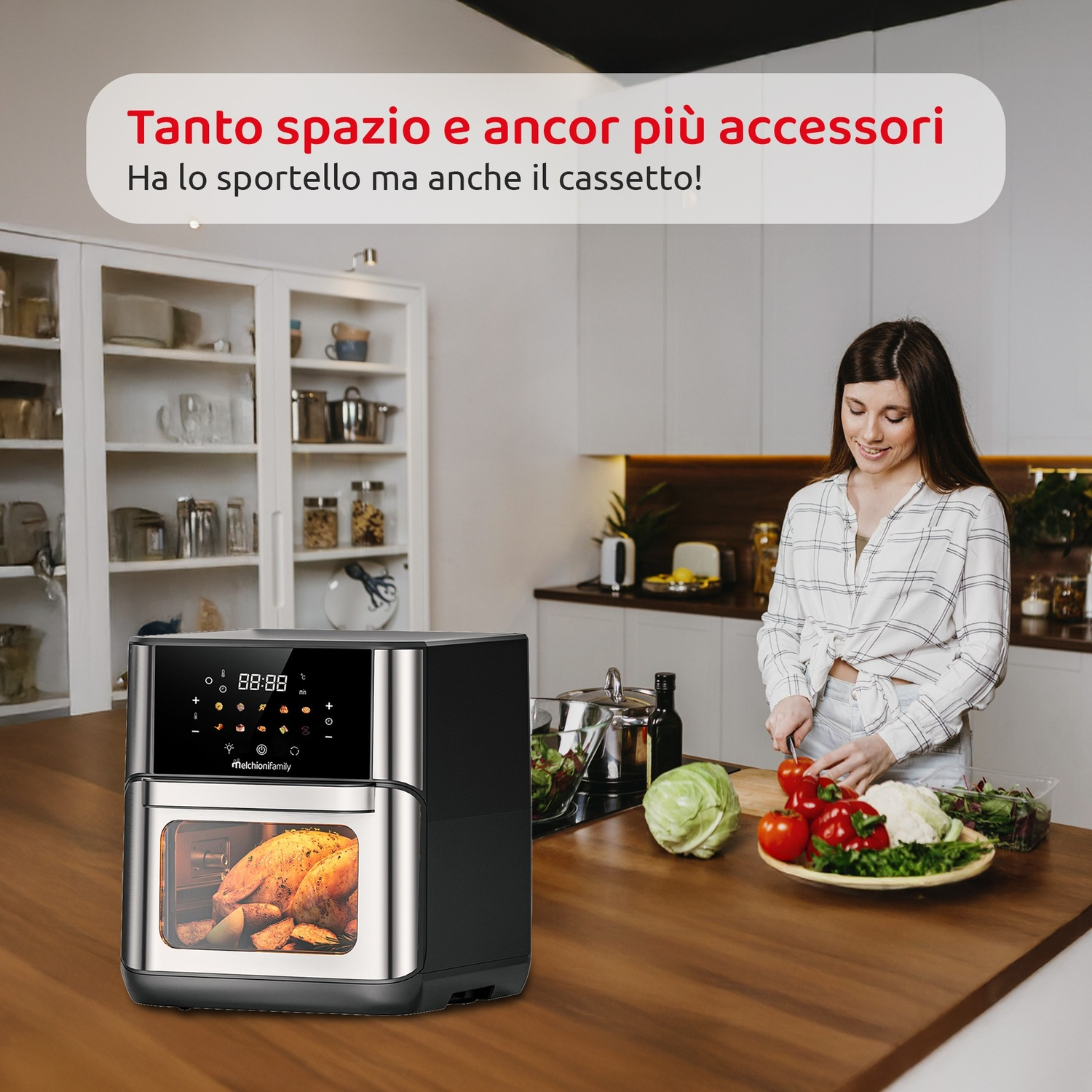 Una donna prepara verdure in cucina, accanto a un tostapane e un armadio pieno.