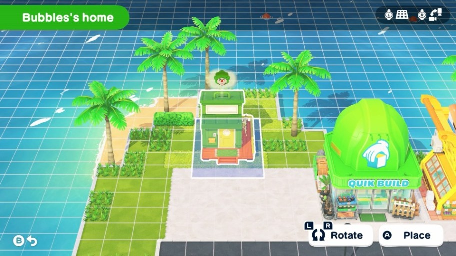 Una villa verde junto al agua con palmeras y una tienda de construcción cerca.