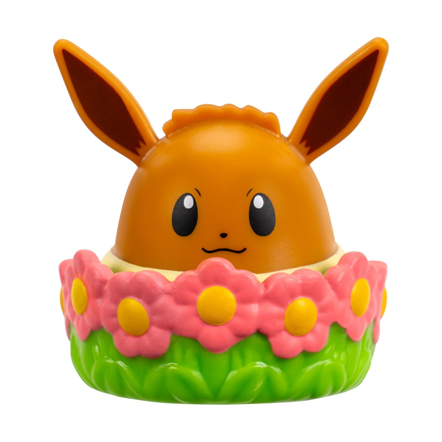 Figura marrone di Eevee circondata da fiori rosa e erba verde.