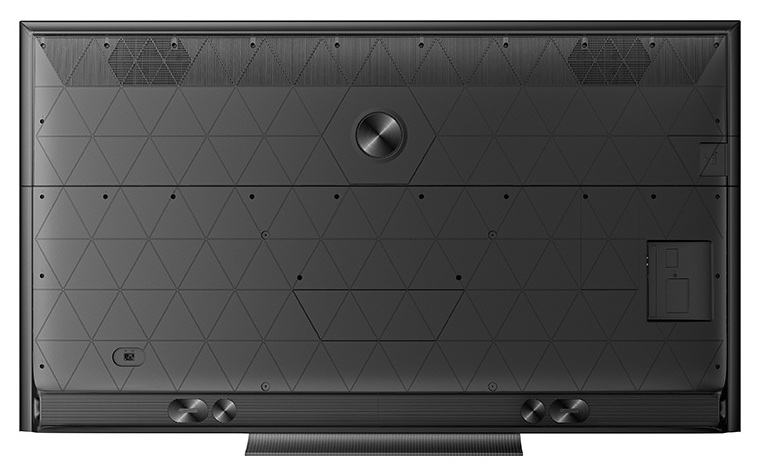 Tył czarnego telewizora z trójkątnym wzorem i portami.