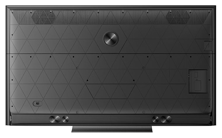 Tył czarnego telewizora z trójkątnym wzorem i portami.