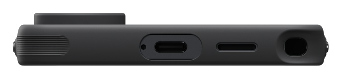 Widok z góry czarnej kamery z portem USB-C, gniazdem SIM i grillem głośnika.