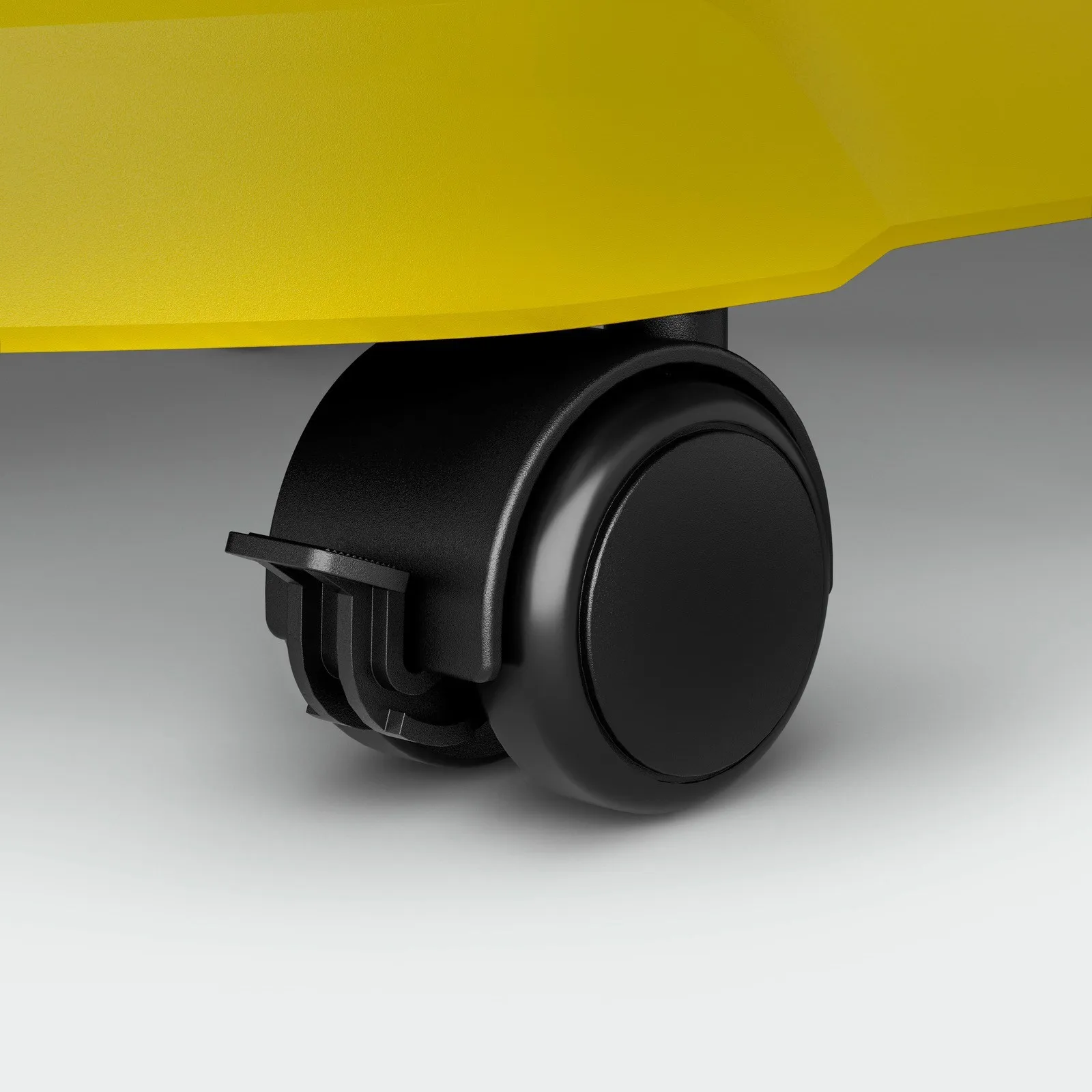 Czarne koło z częścią żółtego obiektu nad nim.