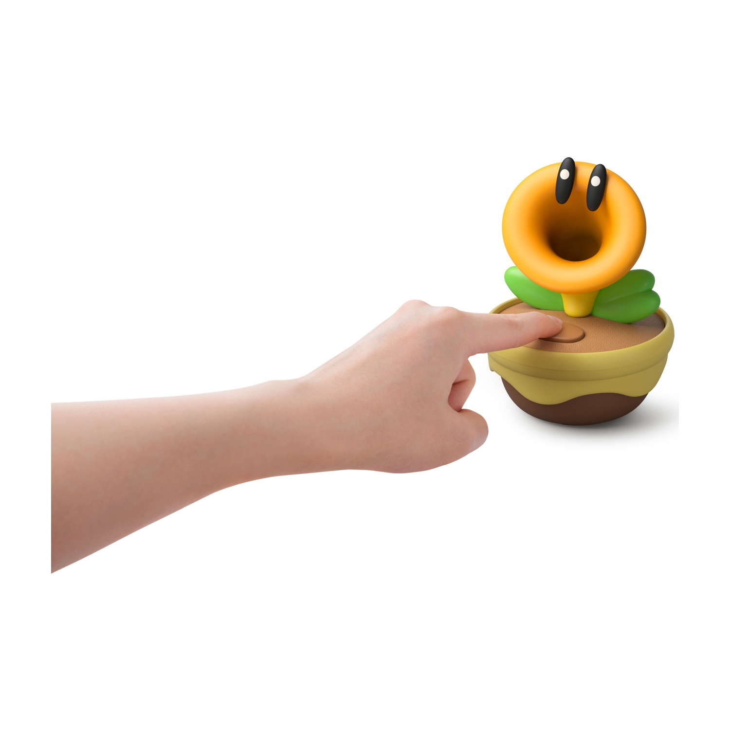 Una mano preme un pulsante marrone su una pianta in vaso con fiore giallo.